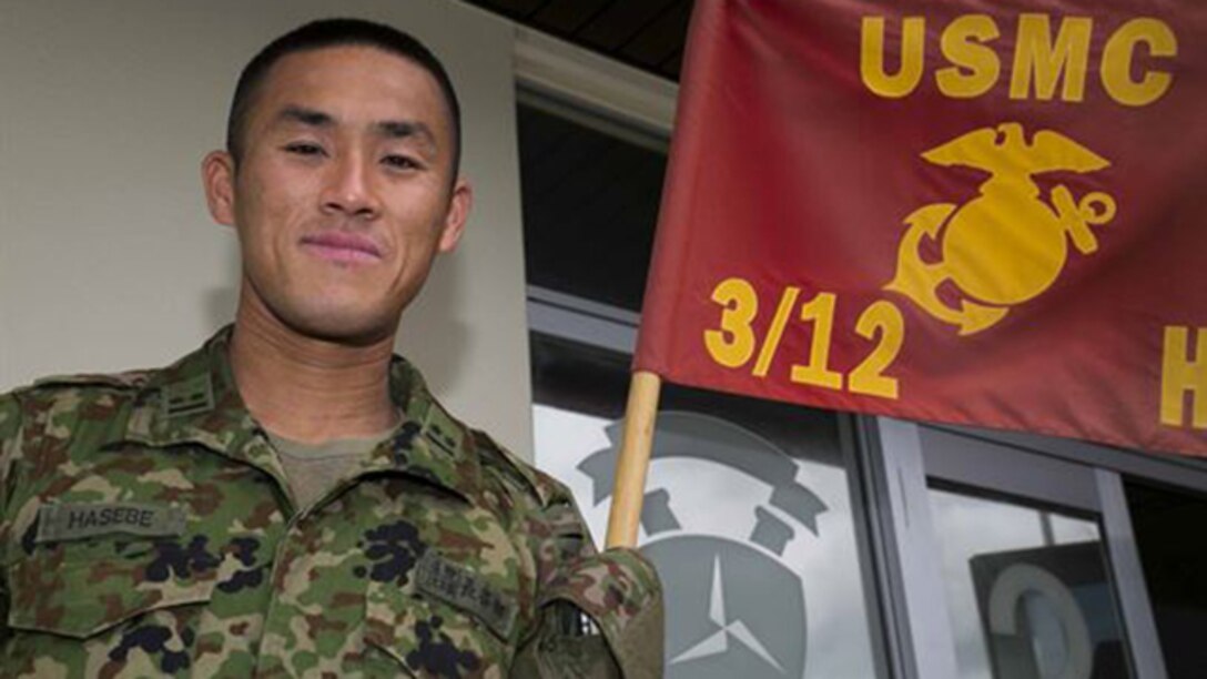 Japanese Ground Self-Defense Force 1st Lt. Ryota Hasebe attached to 3rd Libation 12th Marines, 3rd Marine Division, III Marine Expeditionary Force for two months starting Jan. 11 and ending March 13 poses for a photo aboard Camp Hansen, Okinawa. During those two months Hasebe learned about U.S. Marine Corps artillery and went to Marine Corps Air Ground Combat Center Twentynine Palms, California for Integrated Training Exercise 2-15. Hasebe, 28, studied Chinese Literature and graduated from Kokugakuin University in Tokyo before joining the JGSDF in 2011. Hasebe is now the battalion fire direction control officer for 1st Battalion, 4th Field Artillery Regiment in Fukuoka Japan.