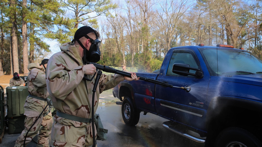Marines with 2nd Marine Logistics Group practice using the M26 Joint Service Transportable Decontamination System during a CBRN decontamination course aboard Camp Lejeune, N.C., March 4, 2015. Students of the week-long course learned about detection of and protection against CBRN agents and the processes of decontaminating troops, equipment and vehicles.