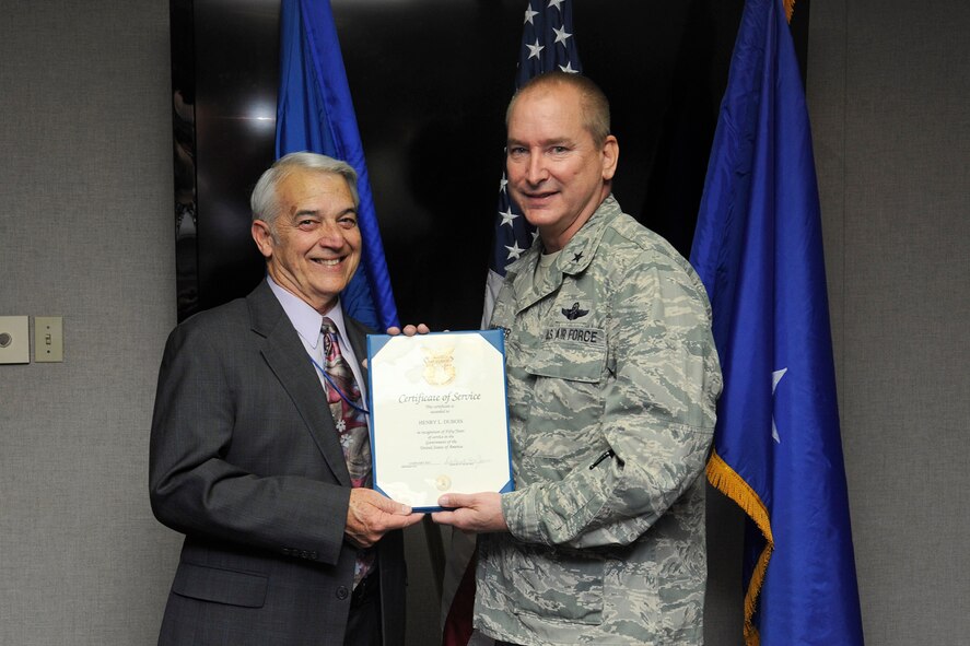Brig. Gen. Stephen Linsenmeyer (right), Air Education and Training Command Directorate of Intelligence, Operations and Nuclear Integration interim director, presents a certificate of service to Hank Dubois, AETC occupational analyst, in honor of his 50 years of civil service Feb. 12 at Joint Base San Antonio-Randolph. (U.S. Air Force photo by Joel Martinez)