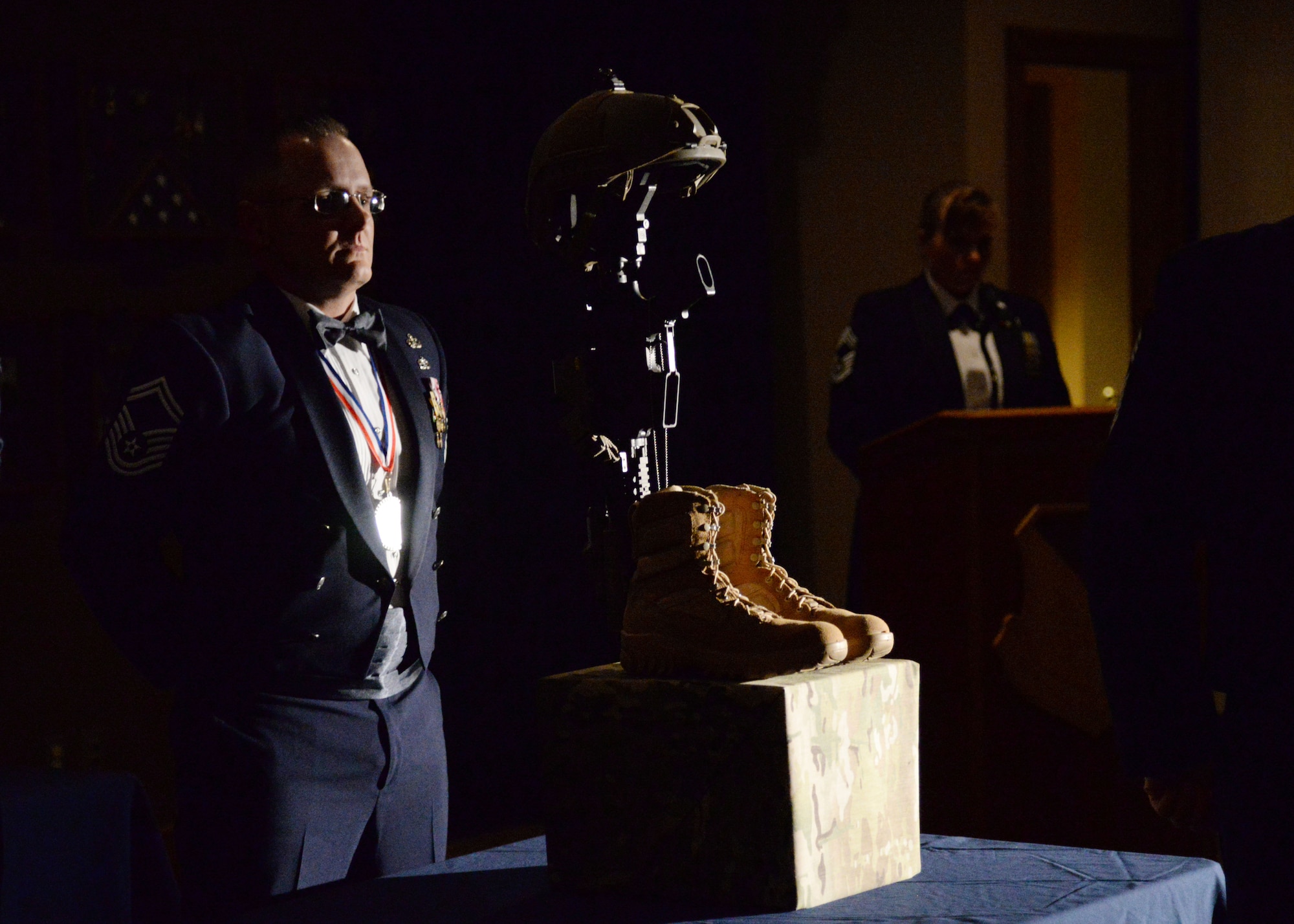U.S. Air Force Senior Master Sgt. James Wadas, 27th Special Operations Communications Squadron superintendent, stands behind the fallen warrior tribute during the Chief Master Sergeant Recognition Ceremony, March 4, 2015 at Cannon Air Force Base, N.M. Air Commandos, families and friends gathered to honor and toast the evening’s high-achievers whose commitment and dedication to the Air Force allowed them to reach the highest level of the enlisted force. (U.S. Air Force photo/Staff Sgt. Alexxis Mercer)