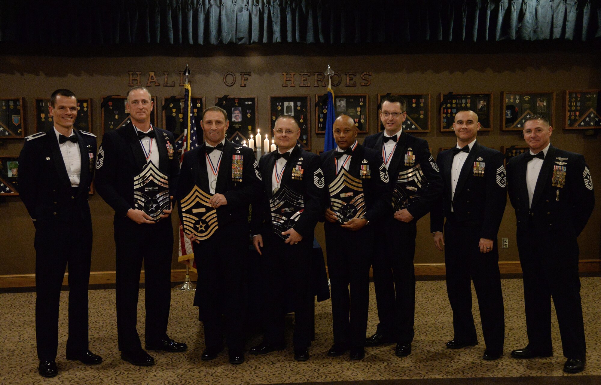 U.S. Air Force Col. Ben Maitre, 27th Special Operations Wing commander, stands with the evening’s five honorees, Chief Master Sgt. Robert Gibbons II, 352nd Special Operations Wing Provisional and Joint Special Operations Air Component Europe command chief, and Chief Master Sgt. Randy Scanlan, 27th SOW command chief, at the Chief Master Sergeant Recognition Ceremony, March 4, 2015 at Cannon Air Force Base, N.M. Only one of every 100 airmen will ever achieve the rank of chief. (U.S. Air Force photo/Staff Sgt. Alexxis Mercer)