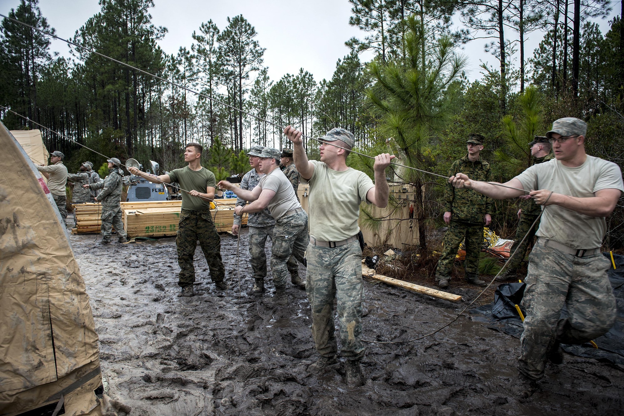Airmen and Marines build a command post Feb. 24, 2015, near Statenville, Ga. Marines from Marine Corps Air Station Beaufort, S.C., are set to use the command post carry out a recovery mission following an F/A-18D Hornet assigned to MCAS Beaufort. The Airmen are assigned to the 23rd Civil Engineer Squadron. (U.S. Air Force photo/Senior Airman Sandra Marrero)