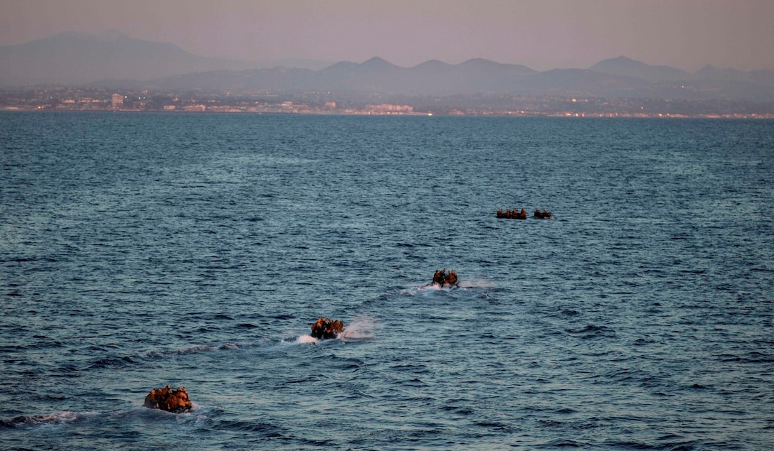 U.S. Marines with the 15th Marine Expeditionary Unit’s Maritime Raid Force depart the USS Essex (LHD 2) in combat rubber raiding craft towards a training beach to execute a precision raid aboard Camp Pendleton March 4, 2015. The 15th MEU is training with their Navy counterparts from Commander, Amphibious Squadron Three during Amphibious Squadron Three/Marine Expeditionary Unit Integration Training (PMINT) off the coast of San Diego. (U.S. Marine Corps photo by Cpl. Elize McKelvey/Released)