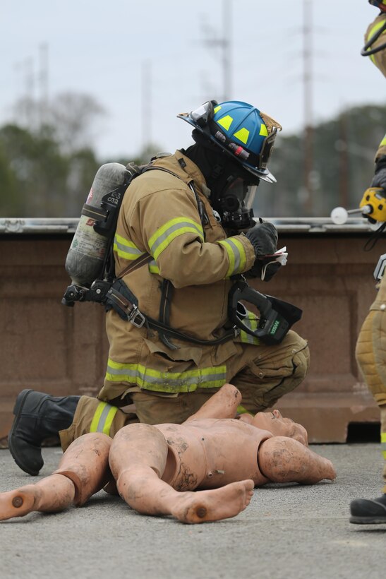 Darryl Phelps documents a casualty during the 2015 Crisis Response Drill at Marine Corps Air Station Cherry Point, N.C., March 3, 2015.  The annual exercise was designed to test Cherry Point’s emergency preparedness program and response procedures. Phelps is a firefighter with Cherry Point’s Fire and Emergency Services Department.