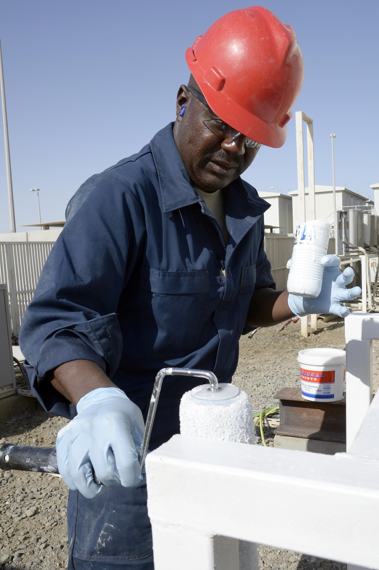 Tech. Sgt. Jeffrey, Expeditionary Prime Base Engineer Emergency Force Squadron heavy equipment operator, paints a heating, ventilation and air conditioning condenser stand at an undisclosed location in Southwest Asia Mar. 2, 2015. Prime BEEF provides installation support by focusing on managing real property, facilities and infrastructure on U.S. or enduring bases in geographic combatant commands outside the U.S.  Jeffrey is currently deployed from the 452nd Civil Engineer Squadron out of March Air Reserve Base, Calif. (U.S. Air Force photo/Tech. Sgt. Marie Brown) (RELEASED)