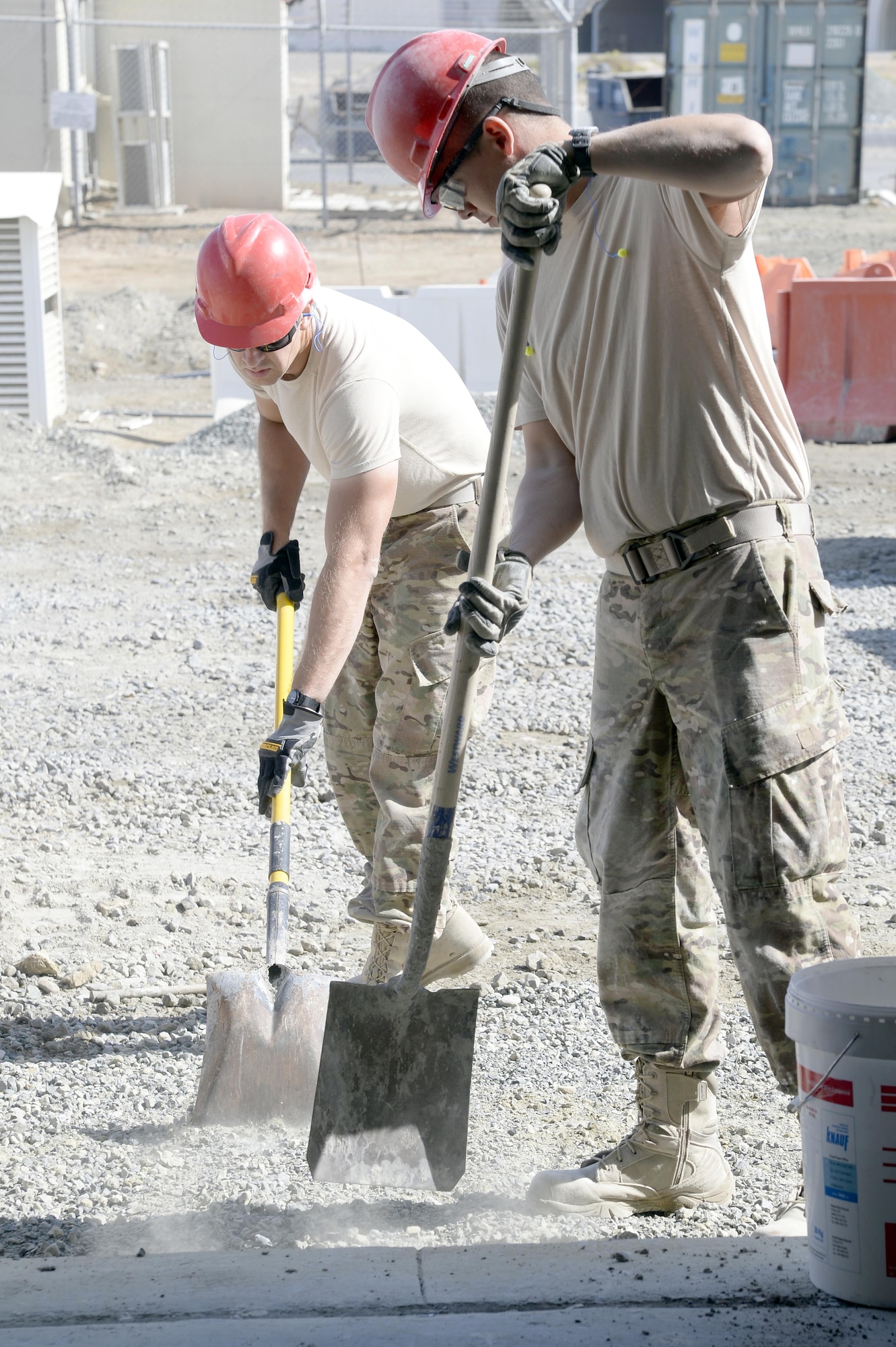 Senior Airman Timothy, front, Expeditionary Prime Base Engineer Emergency Force Squadron water and fuels system manager, and Tech. Sgt. John, Expeditionary Prime Base Engineer Emergency Force Squadron power production, level stone at the Roy’s Kitchen construction site at an undisclosed location in Southwest Asia Mar. 2, 2015. The EPBS has been working on a variety of projects consisting of an airfield security fence, replacing about $280K worth of new showers in the Army barracks as well as constructing a 13.5’x13.5’x8’, 12-inch thick concrete electrical vault and 31 foot reinforced horizontal stem wall for the Communications Squadron. Timothy is currently deployed from the 434th Civil Engineer Squadron out of Grissom Air Reserve Base, Ind., and is a native of Springfield, Ill. John is currently deployed out of the 155th Civil Engineer Squadron, Lincoln Air National Guard, Neb., and is a native of Beatrice, Neb. (U.S. Air Force photo/Tech. Sgt. Marie Brown) (RELEASED)