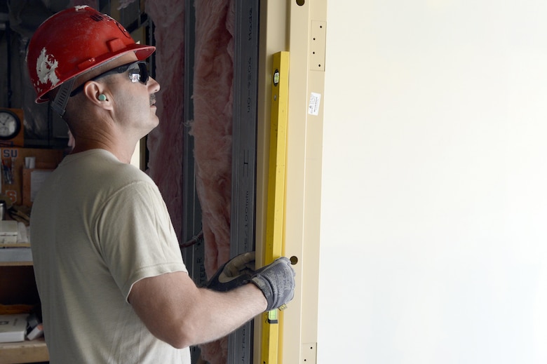 Staff Sgt. Charles, Expeditionary Prime Base Engineer Emergency Force Squadron water and fuels system manager, installs a metal door frame to the entrance of Roy’s Kitchen at an undisclosed location in Southwest Asia Mar. 2, 2015. The expansion of Roy’s Kitchen will include an additional 2,500 square feet of seating and cooking space. Charles is currently deployed from the 174th Civil Engineer Squadron out of Stratton Air National Guard Base, Syracuse, N.Y., and is a native of Macedon, N.Y. (U.S. Air Force photo/Tech. Sgt. Marie Brown) (RELEASED)