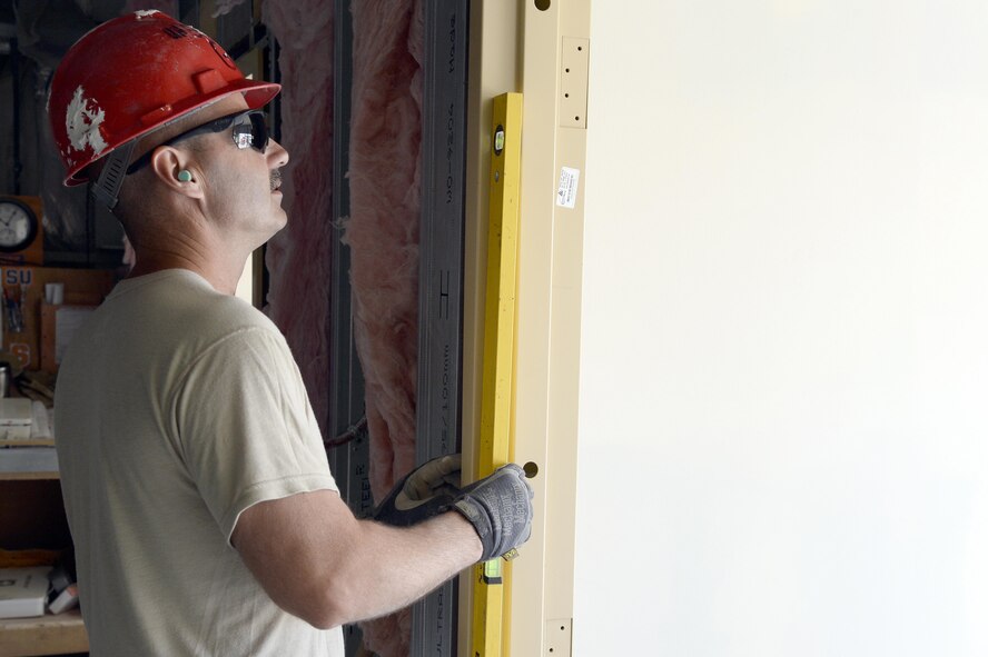 Staff Sgt. Charles, Expeditionary Prime Base Engineer Emergency Force Squadron water and fuels system manager, installs a metal door frame to the entrance of Roy’s Kitchen at an undisclosed location in Southwest Asia Mar. 2, 2015. The expansion of Roy’s Kitchen will include an additional 2,500 square feet of seating and cooking space. Charles is currently deployed from the 174th Civil Engineer Squadron out of Stratton Air National Guard Base, Syracuse, N.Y., and is a native of Macedon, N.Y. (U.S. Air Force photo/Tech. Sgt. Marie Brown) (RELEASED)