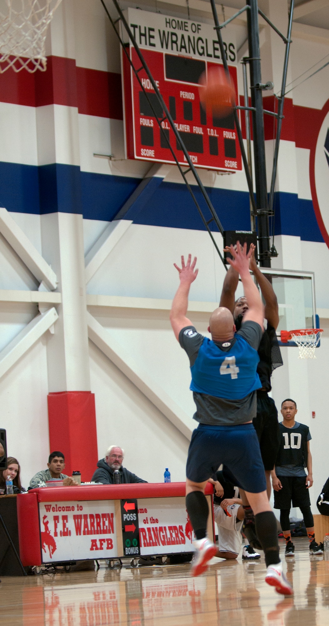 A member of the 90th Force Support Squadron Basketball team attempts to block a basketball shot during the 2015 Intramural Basketball Game March 4, 2015, in the Freedom Hall Fitness Center on F.E. Warren Air Force Base, Wyo. The 90th SFG team won the championship game with a score of 58 against the 90th FSS team who scored 49. (U.S. Air Force photo by Airman 1st Class Malcolm Mayfield)