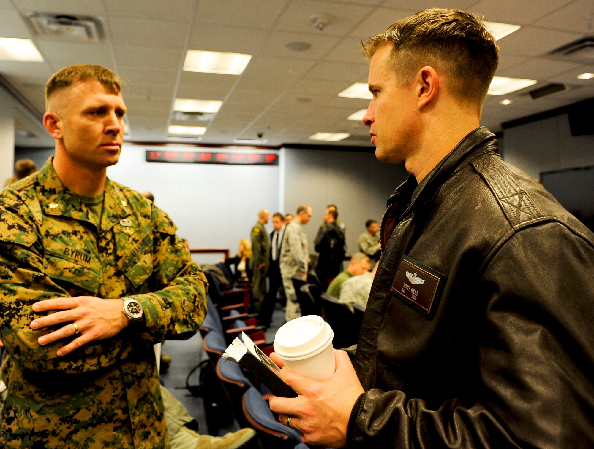 Marine Maj. Dustin Byrum (left), Air Officer Department Head, Marine Aviation Weapons and Tactics Squadron One, Yuma, Ariz. , and Air Force Maj. Scott Mills, 66th Weapons Squadron commander, Nellis Air Force Base, Nev., share their thoughts before the morning briefing as part of the Future Close Air Support Focus Week March 4, at the Pentagon. (U.S. Air Force photo/Tech. Sgt. Anthony Nelson Jr.)