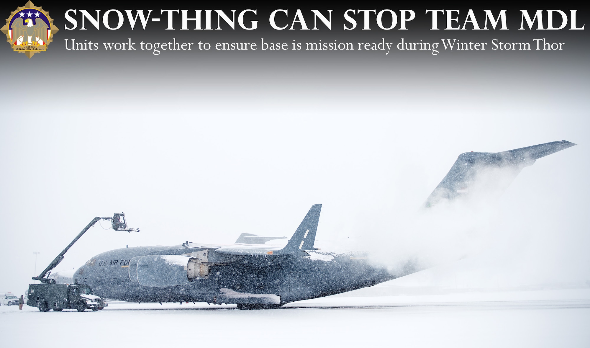 Vince White, 305th Maintenance Group Transient Alert aircraft servicer, de-ices a C-17 Globemaster in preparation for flight during Winter Storm Thor March 5, 2015 at Joint Base McGuire-Dix-Lakehurst, N.J. The aircraft landed at JB MDL on its way back to Joint Base Lewis-McChord. Members of both joint bases worked together to prepare the aircraft to fly safely in the storm. (U.S. Air Force illustration by Staff Sgt. Katherine Tereyama/RELEASED)