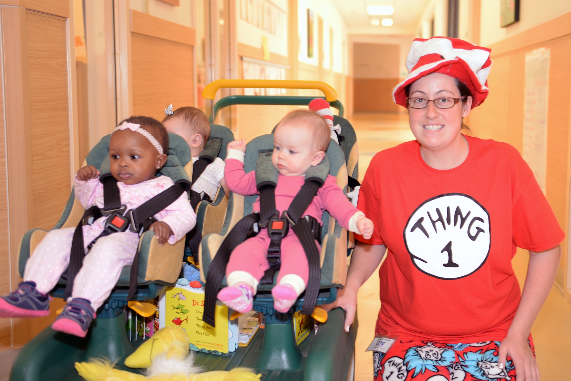 Beth Rybin, Child Development Center II program assistant, poses with infants, Brielle Irvin, left, daughter of U.S. Air Force Airman 1st Class Winisha Irvin, 23d Comptroller Squadron and Kylie Crawford, middle, daughter of Senior Airman Heather Windsor, 820th  Base Defense Group, during Pajama Day March 5, 2015, at Moody Air Force Base, Ga. The week kicked off with a silly sock day followed by wacky Wednesday. (U.S. Air Force photo by Airman Greg Nash/Released)