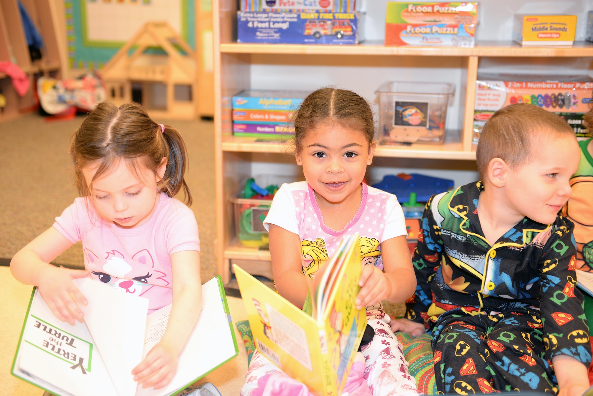 Sofia Rosa, middle, daughter of Staff Sgt. Serafin Rosa, 23d Civil Engineer Squadron, participates in Pajama Day at the Child Development Center II March 5, 2015, at Moody Air Force Base, Ga. The CDC and Moody Youth Programs hosted various events in honor of Dr. Seuss week. (U.S. Air Force photo by Airman Greg Nash/Released) 