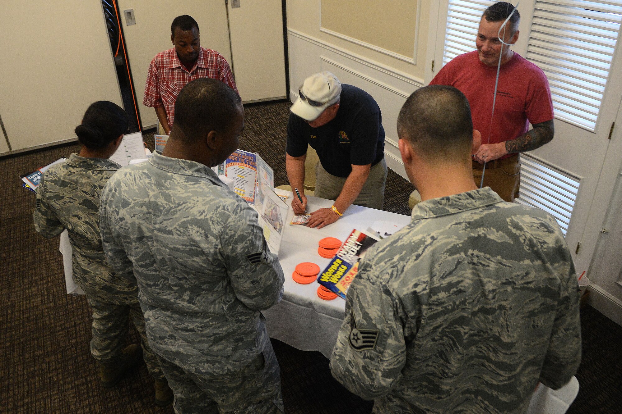 U.S. Air Force Airmen talk with members of the 20th Force Support Squadron Outdoor Recreation Center about different services they provide during a 20th Force Support Squadron travel fair at the Carolina Skies Club and Conference Center at Shaw Air Force Base, S.C., March 4, 2015. Throughout the event, service members and their families were able to talk with various vendors about the vacation and trip services that are provided. (U.S. Air Force photo by Airman 1st Class Michael Cossaboom/Released)