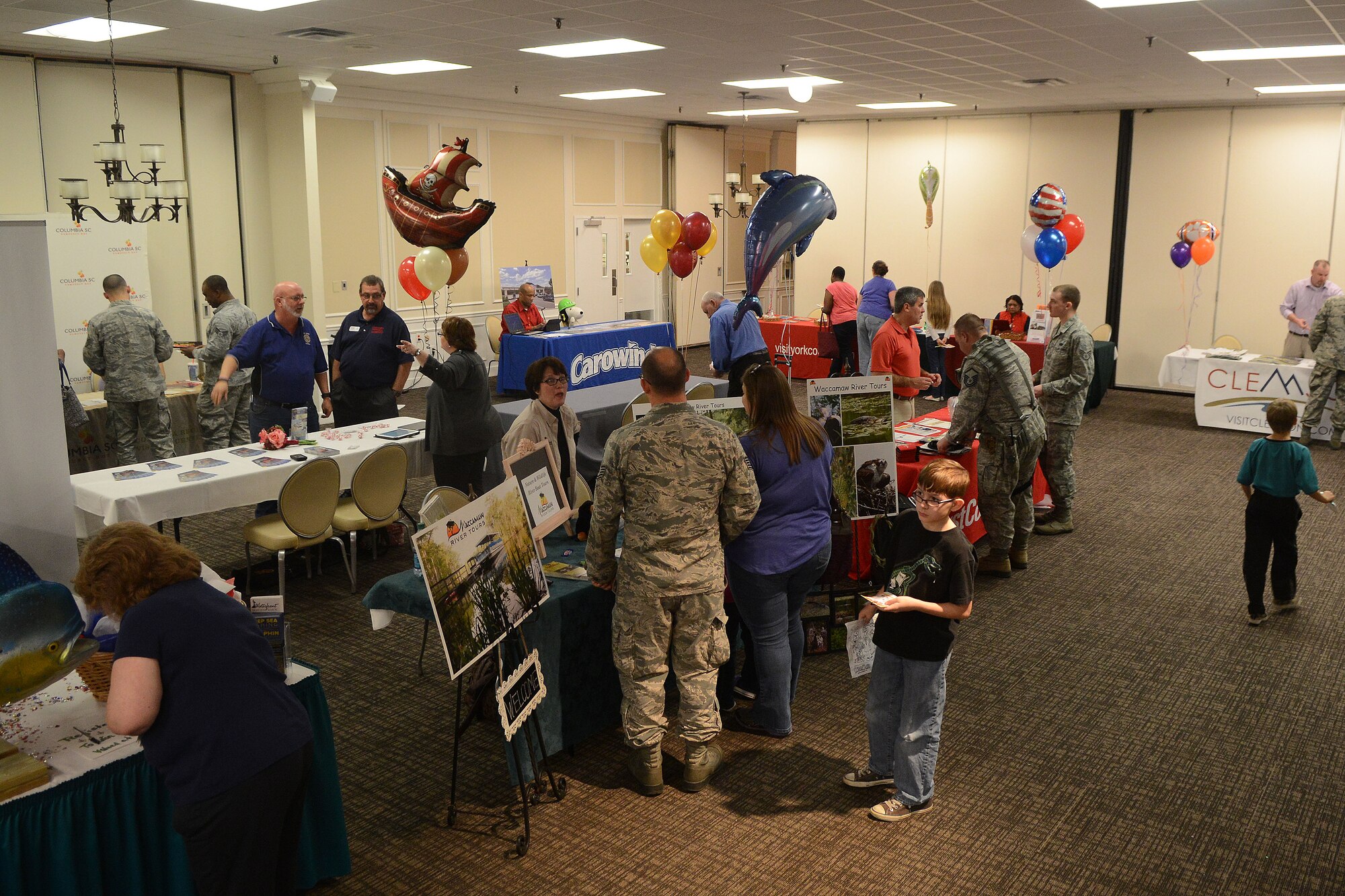 Members of Team Shaw visit various venues at a 20th Force Support Squadron travel fair at the Carolina Skies Club and Conference Center at Shaw Air Force Base, S.C., March 4, 2015. The 20th FSS hosted the event to show service members and their families different travel and vacation ideas they can partake in while at Shaw. (U.S. Air Force photo by Airman 1st Class Michael Cossaboom/Released)