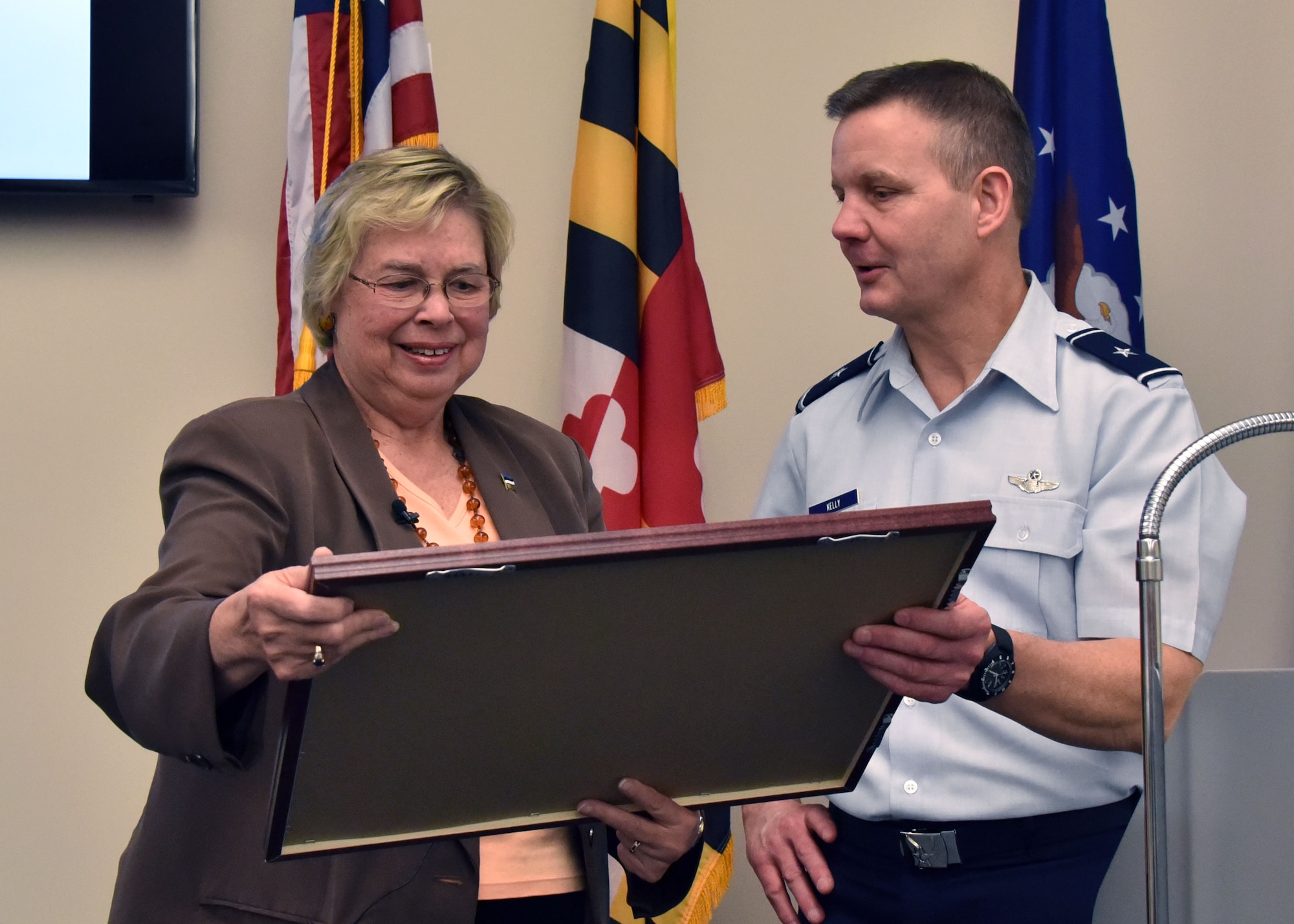 Brig. Gen. Scott Kelly, 175th Wing commander presents Marju Rink-Abel, president of the Estonian American National council, a photo collage after she spoke at Warfield Air National Guard Base on February 8, 2015. Rink-Abel provided Maryland Air National Guardsmen a detailed overview of Estonia, Maryland’s State Partnership Program partner since 1993, Many of the Airmen have either been to Estonia or will go in the near future. (U.S. Air National Guard photo by 2nd Lt. Benjamin Hughes/RELEASED) 