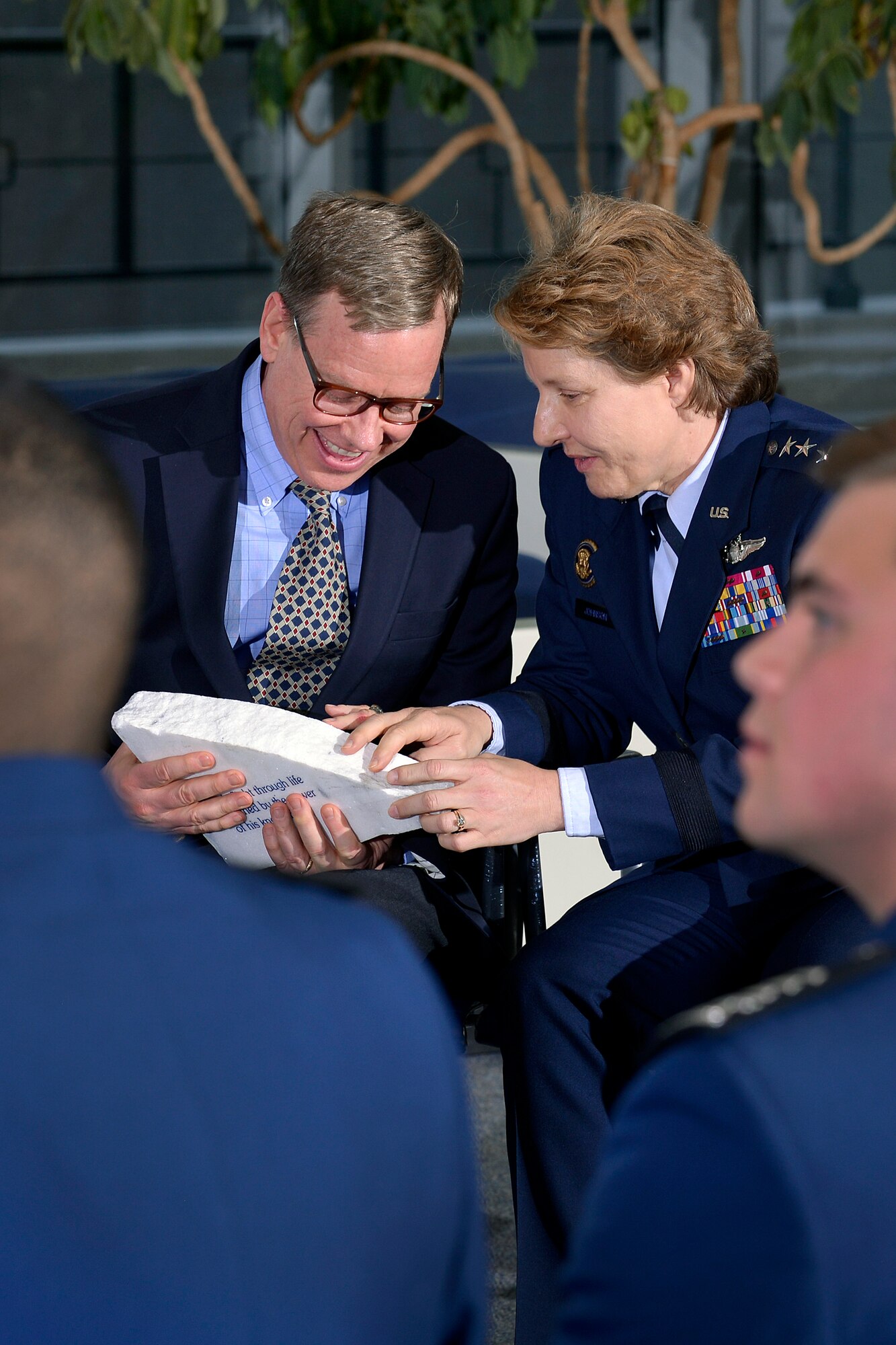 Intel Corporation's principal strategist Keith Uebele and Academy Superintendent Lt. Gen. Michelle D. Johnson chat about the inscribed piece of the terrazzo Uebele received from the Cadet Wing  during the 19th-annual Research Awards Ceremony here March 3, 2015.  Uebele was the event's keynote speaker and spoke to cadets about the value of research innovation.  Uebele is a liaison connecting Intel Corp with the Homeland Security Department’s Center of Innovation here. (U.S. Air Force photo/Jason Gutierrez)