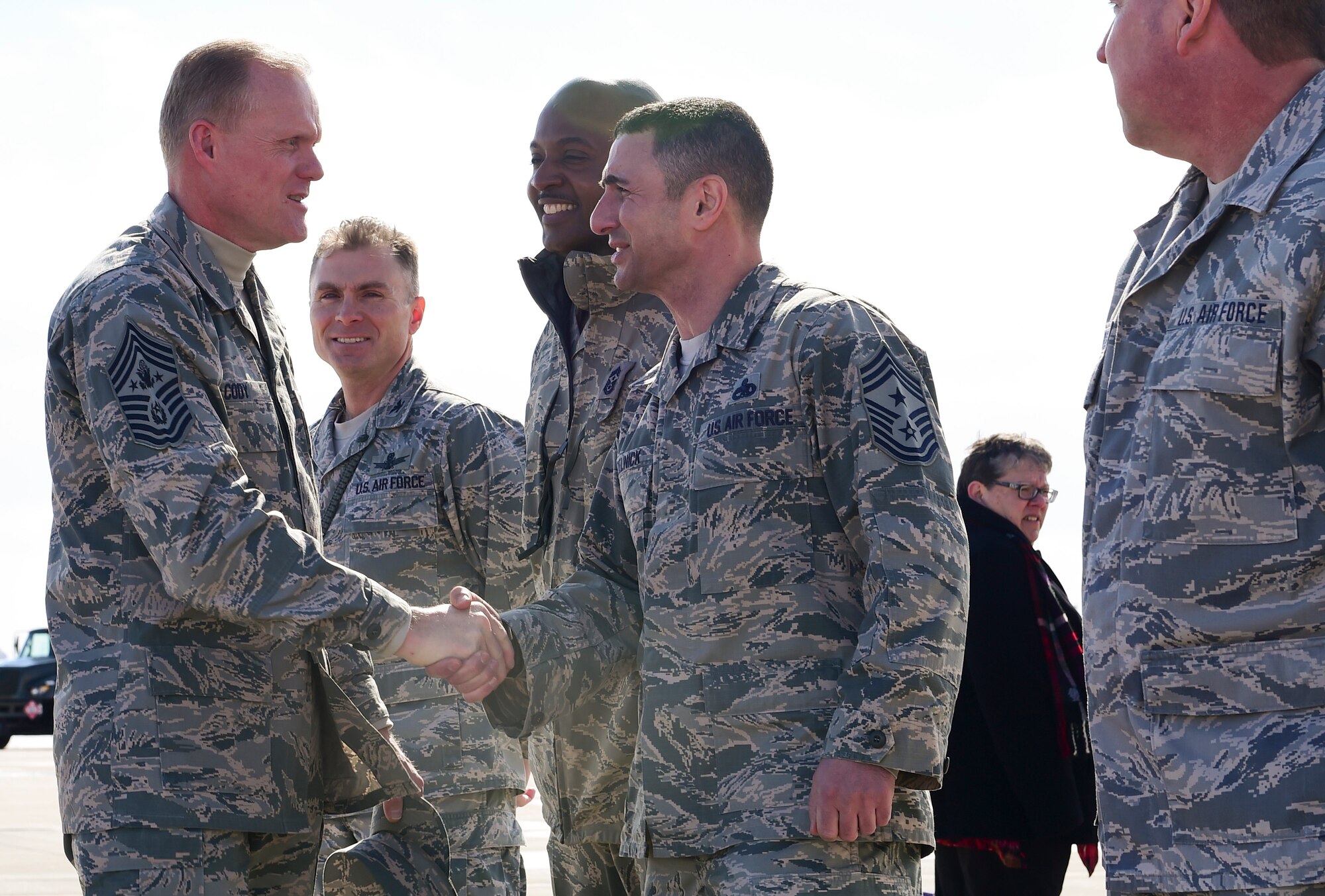 Chief Master Sgt. of the Air Force James A. Cody greets Chief Master Sgt. Brian Kruzelnick, 460th Space Wing command chief, upon his arrival March 5, 2015, at Buckley Air Force Base, Colo. Cody toured Buckley and spoke with Airmen on the future of the Air Force. (U.S. Air Force photo by Airman 1st Class Luke W. Nowakowski/Released)