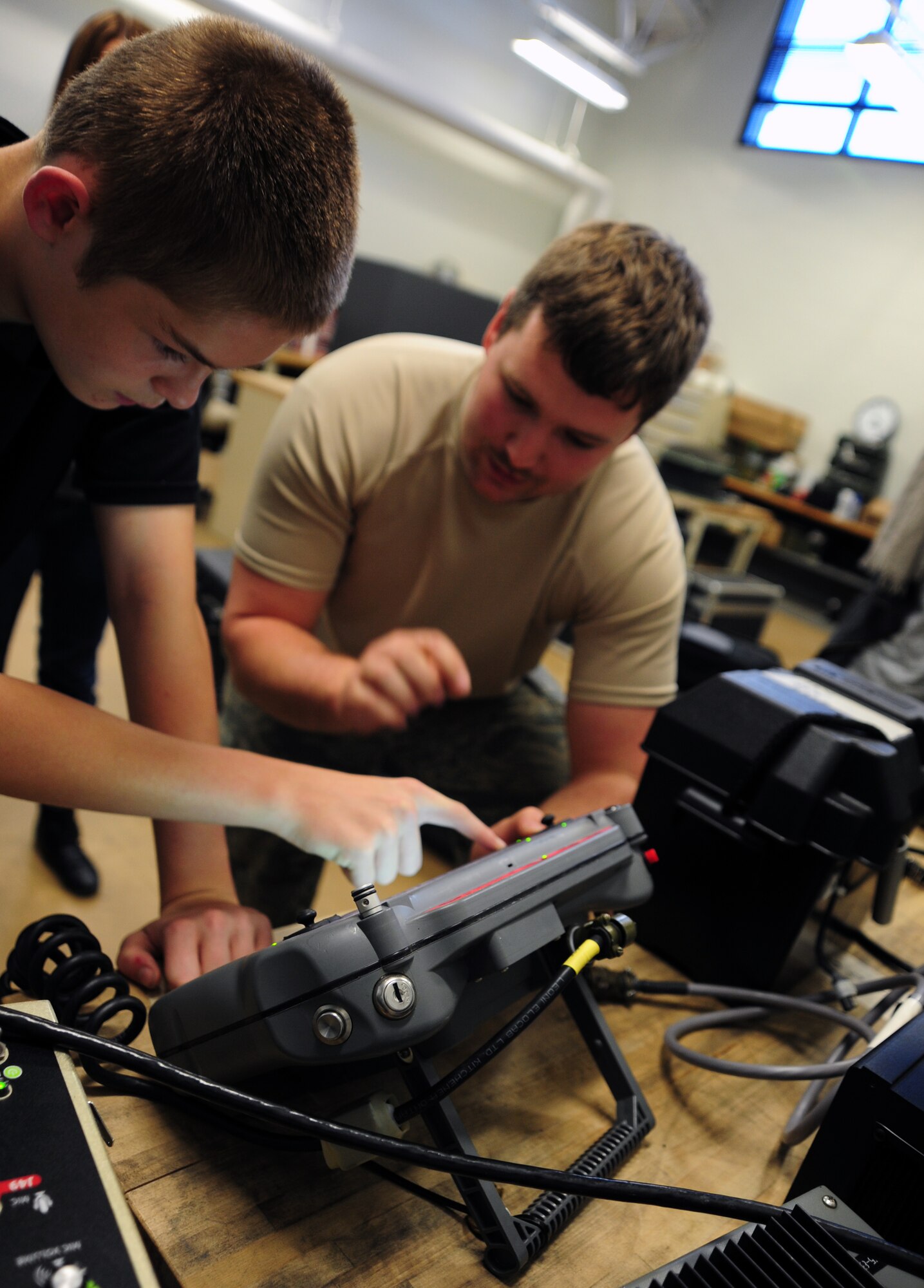 Gage Baska, a 14 year-old resident of Blue Springs, Mo., controls an Air Force medium-sized robot with a remote-search and disablement tool at Whiteman Air Force Base, Mo., Nov. 5, 2014. Gage toured EOD and a wide range of other units on base as part of an intervention program. (U.S. Air Force photo by Staff Sgt. Nick Wilson/Released)