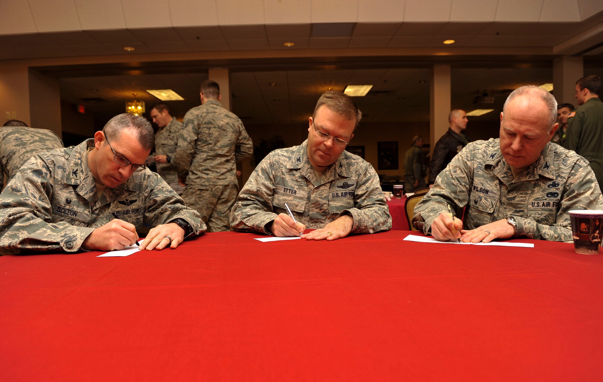 Col. Charles Bolton, the 19th Operations Group commander, Col. William Otter, 19th Airlift Wing vice commander, and Col. Joseph Wilson, 189th Airlift Wing vice commander, sign their Air Force Assistance Fund forms March 3, 2015, at Little Rock Air Force Base, Ark. Team Little Rock’s overall goal this year is to have 100 percent contact, at least 90 percent contribution and raise approximately $79, 000. (U.S. Air Force photo by Senior Airman Regina Edwards)