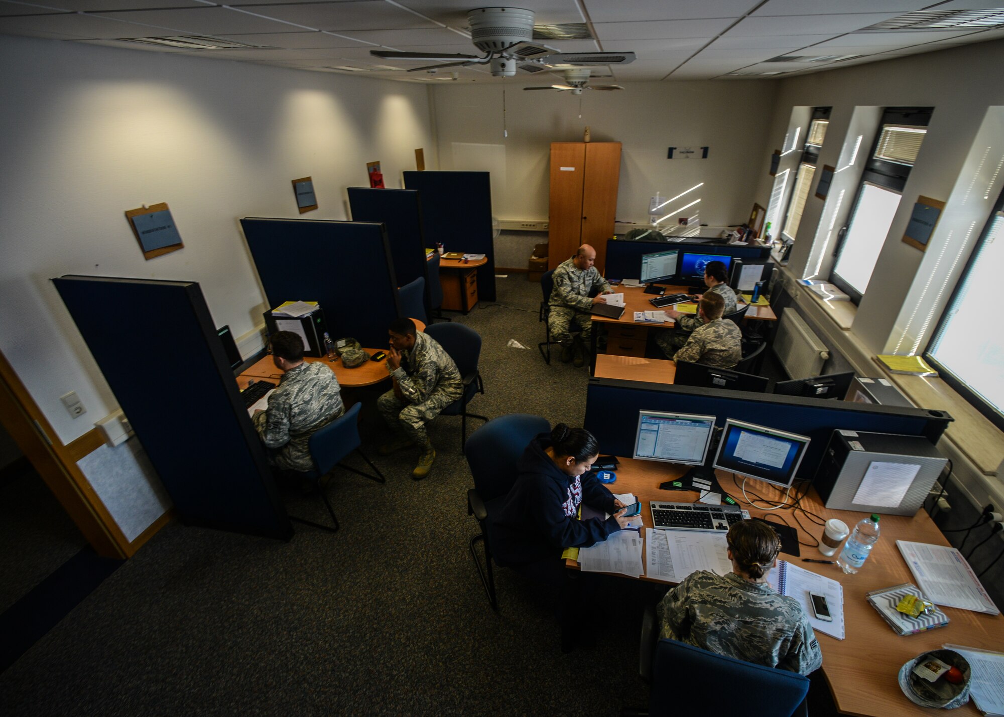 Tax center volunteers file tax returns for customers at Ramstein Air Base, Germany, March 6, 2015. The tax center files federal and state taxes for active duty military, dependents and retirees free of charge. (U.S. Air Force photo/Senior Airman Nicole Sikorski)
