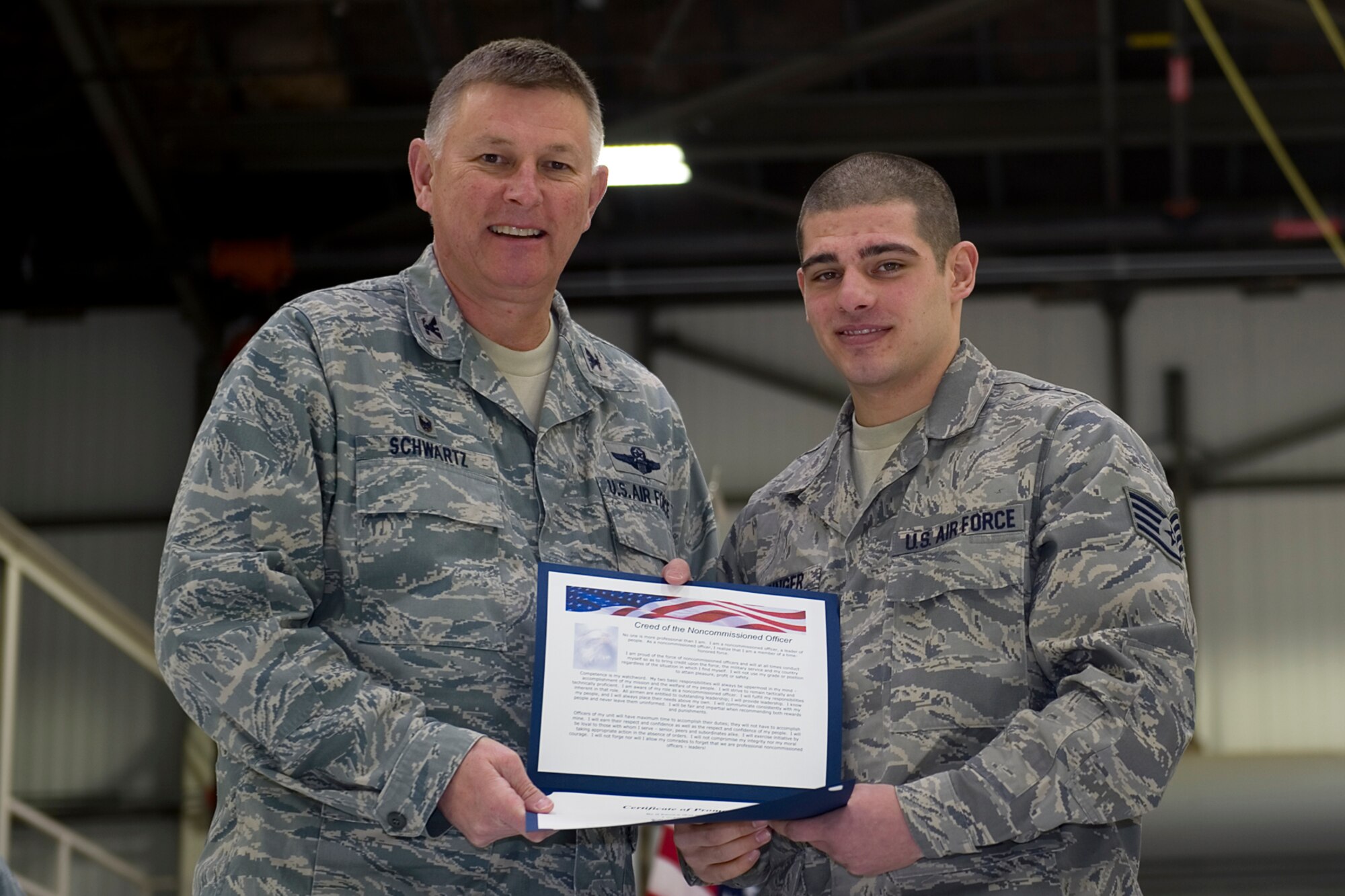 Staff Sgt. Chase Sprunger, 434th Maintenance Squadron crew chief, is presented with a certificate of promotion by Col. Doug Schwartz, 434th Air Refueling Wing commander, during a non-commissioned officer induction ceremony at Grissom Air Reserve Base, Ind., Feb. 7, 2015. Sprunger along with three staff sergeants and two master sergeants were inducted in the ranks of NCO and senior NCO. (U.S. Air Force photo/ Senior Airman Jami K. Lancette)
