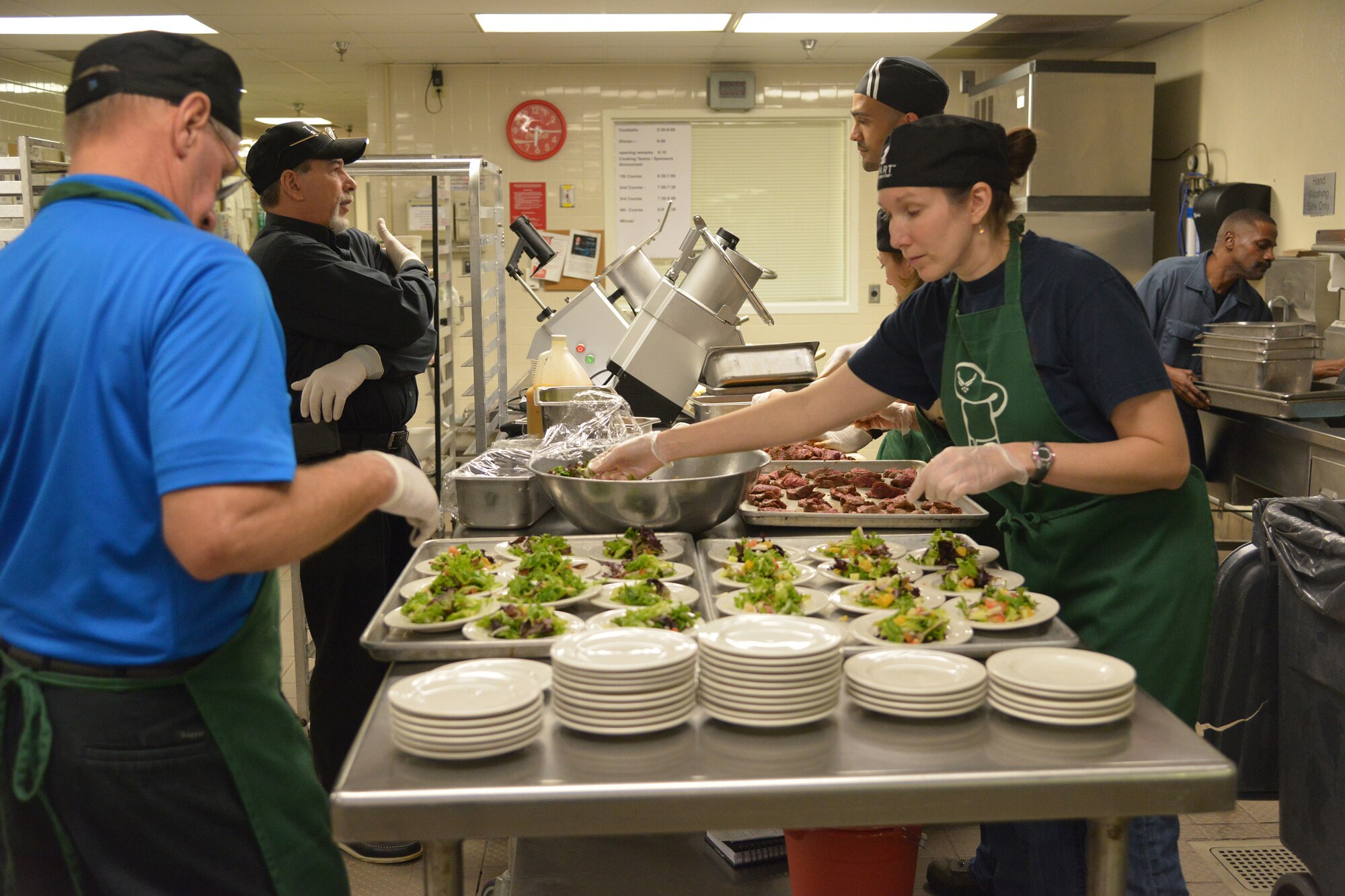 Green Team members are busy at work putting together a colorful appetizer dish. (U.S. Air Force photo by Ray Crayton) 