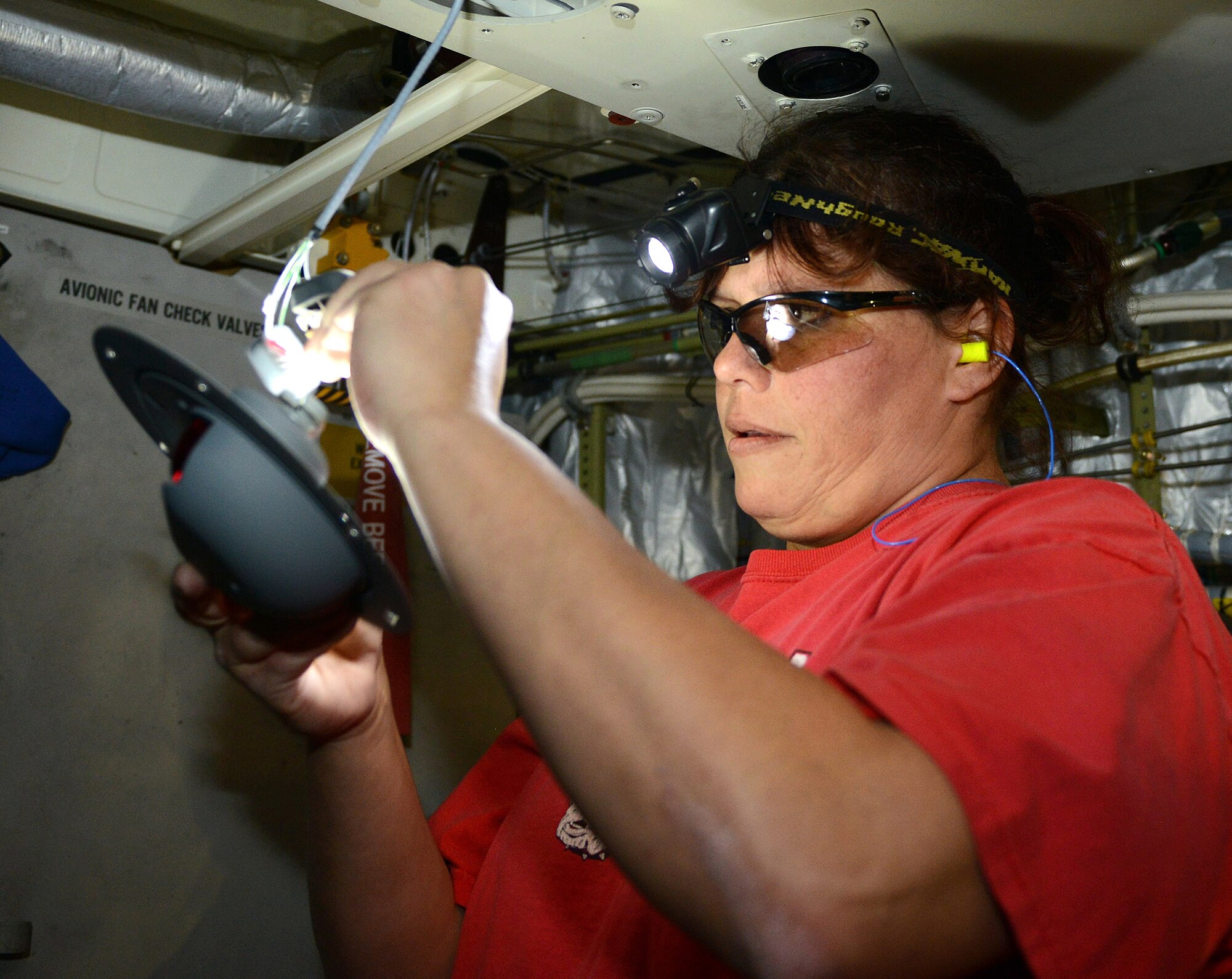 Susan Floyd, 402nd Electronics Maintenance Group electronics mechanic, installs a C-17 forward loadmaster light panel. (U.S. Air Force photo by Tommie Horton)