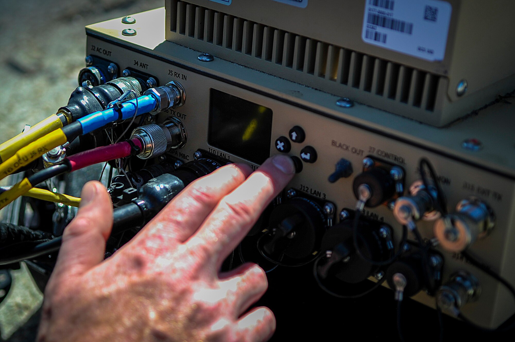 A member of the Joint Communications Support Element configures a Hawkeye two-way satellite ground station during the technical training day of Warrior Spirit at MacDill Air Force Base, Fla., March 3, 2015. One team setup on the beaches of MacDill and the other on Pine Key to assess the teams’ abilities to setup radio and satellite communications from deployed locations. (U.S. Air Force photo by Senior Airman Ned T. Johnston/Released)