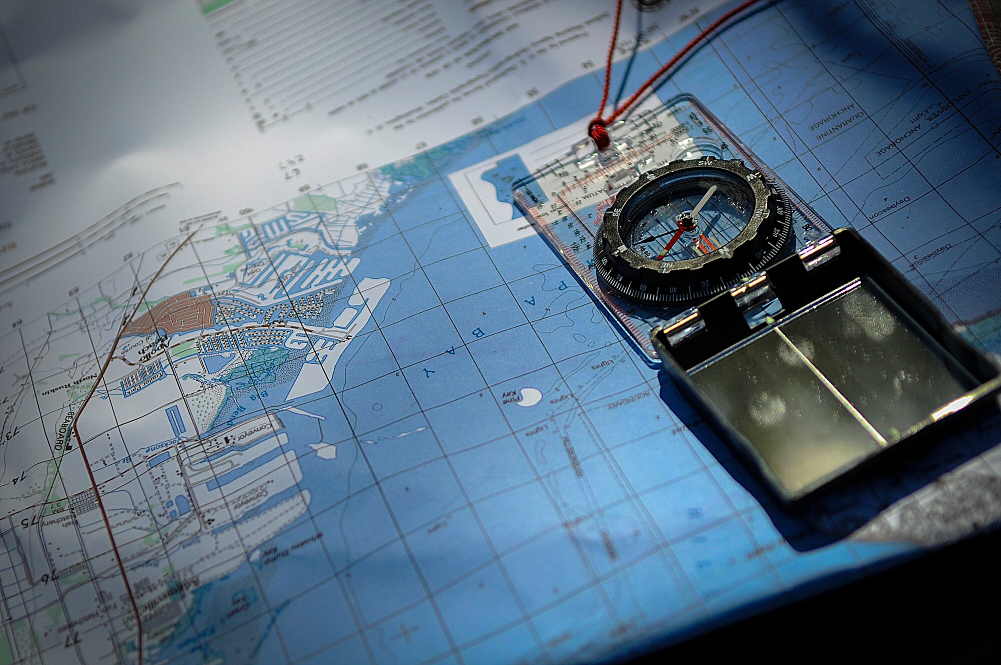 A compass and map are used by the Joint Communications Support Element during Warrior Spirit ’15 to establish two-way satellite and radio communications with other teams from the beaches on MacDill Air Force Base, Fla., to Pine Key. Warrior Spirit was a week-long exercise that evaluated JCSE members’ readiness to deploy. (U.S. Air Force photo by Senior Airman Ned T. Johnston/Released)