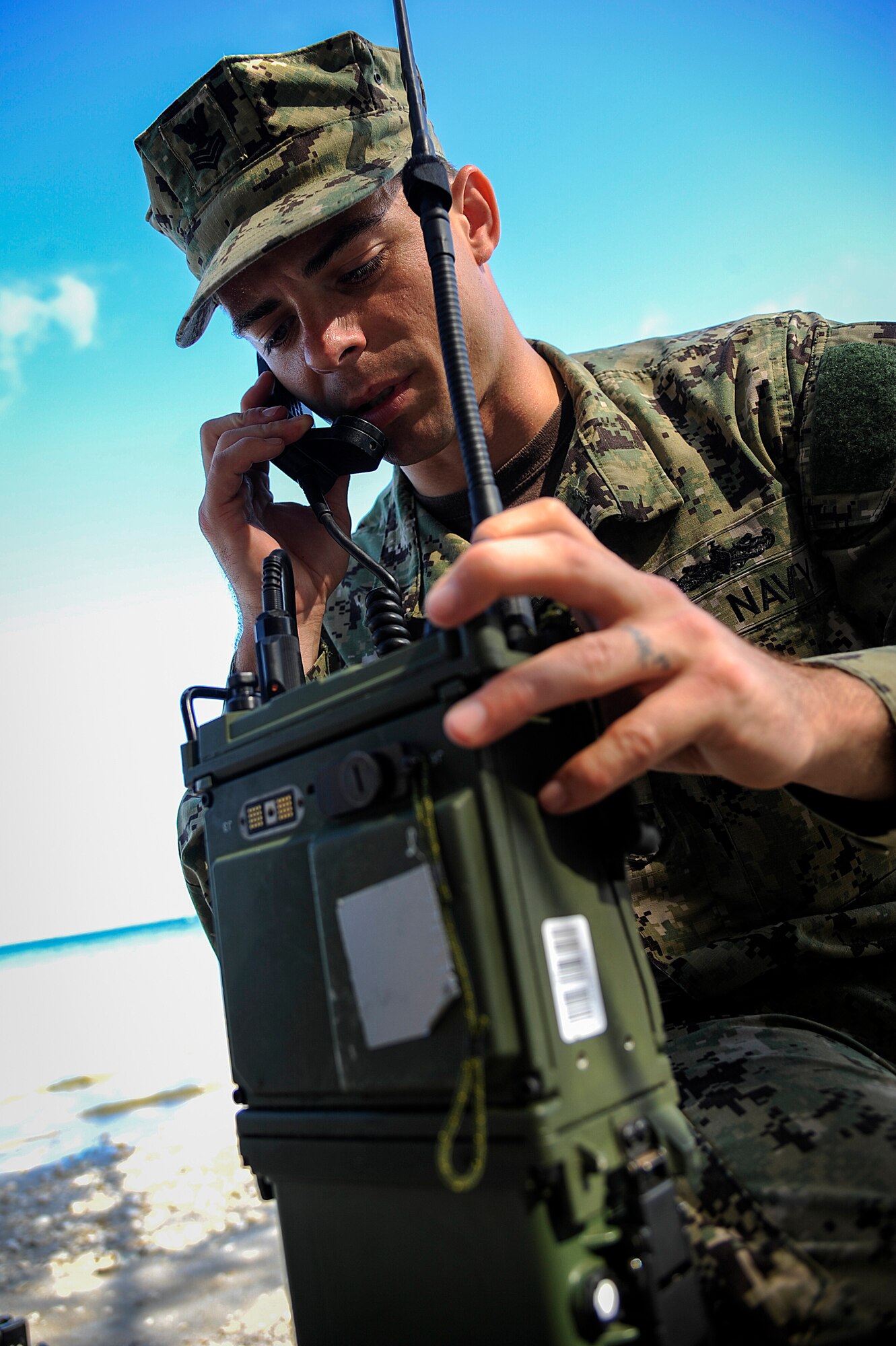 Navy Petty Officer 1st Class Jared Higginbotham, Joint Communications Support Element electronics technician, uses a radio to contact another communications team across Hillsborough Bay on MacDill Air Force Base, Fla., March 3, 2015. Warrior Spirit assessed JCSE members' readiness to deploy and areas of their job where they might need more training. (U.S. Air Force photo by Senior Airman Ned T. Johnston/ Released)