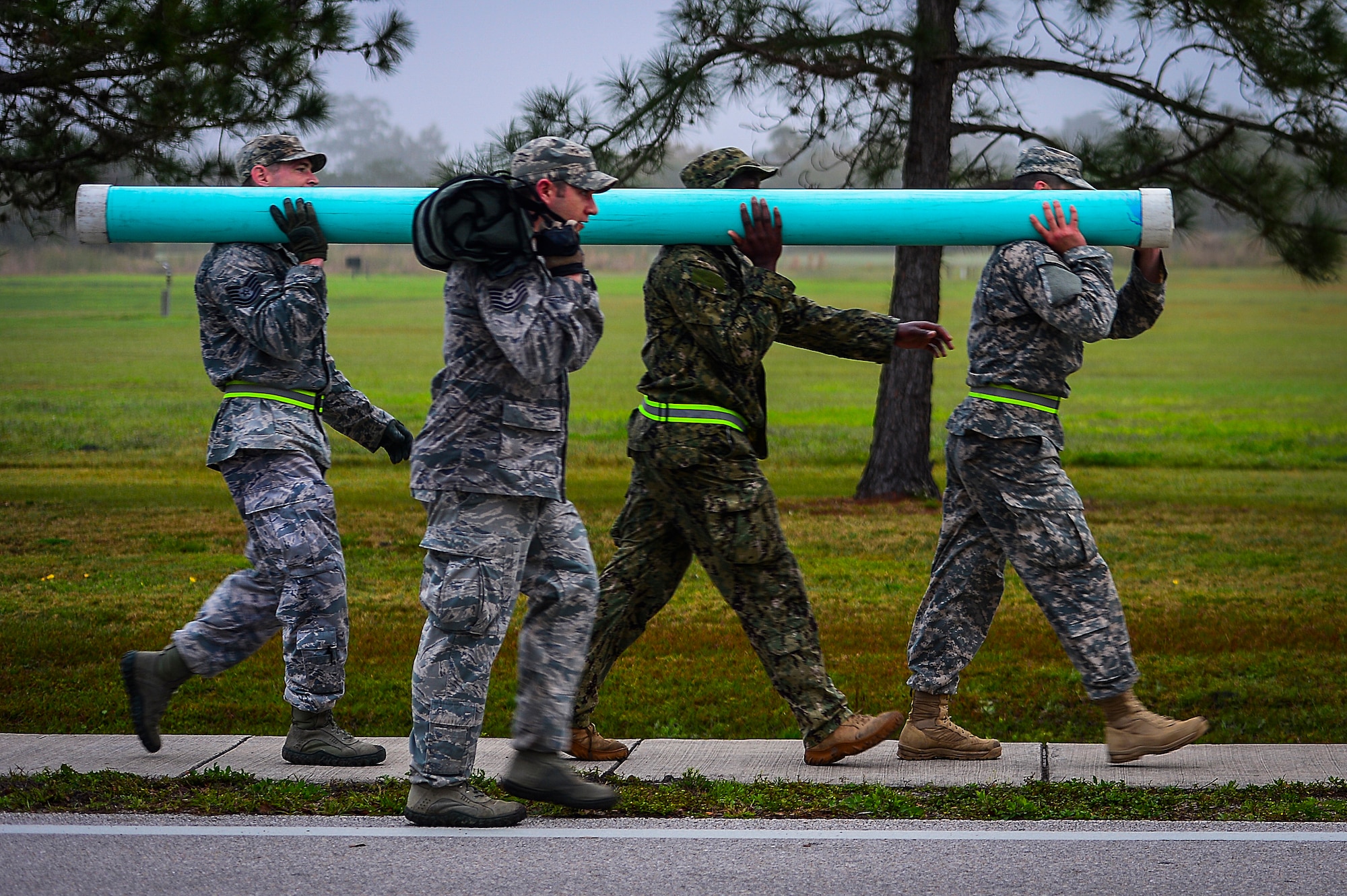 Members of the Joint Communications Support Element carry a weighted PVC pipe during the “log carry” portion of Warrior Spirit ’15 at MacDill Air Force Base, Fla., March 2, 2015. Warrior Spirit was a week-long exercise that tested JCSE's rapid-deployment capabilities, and ability to communicate worldwide. (U.S. Air Force photo by Senior Airman Ned T. Johnston/Released)
