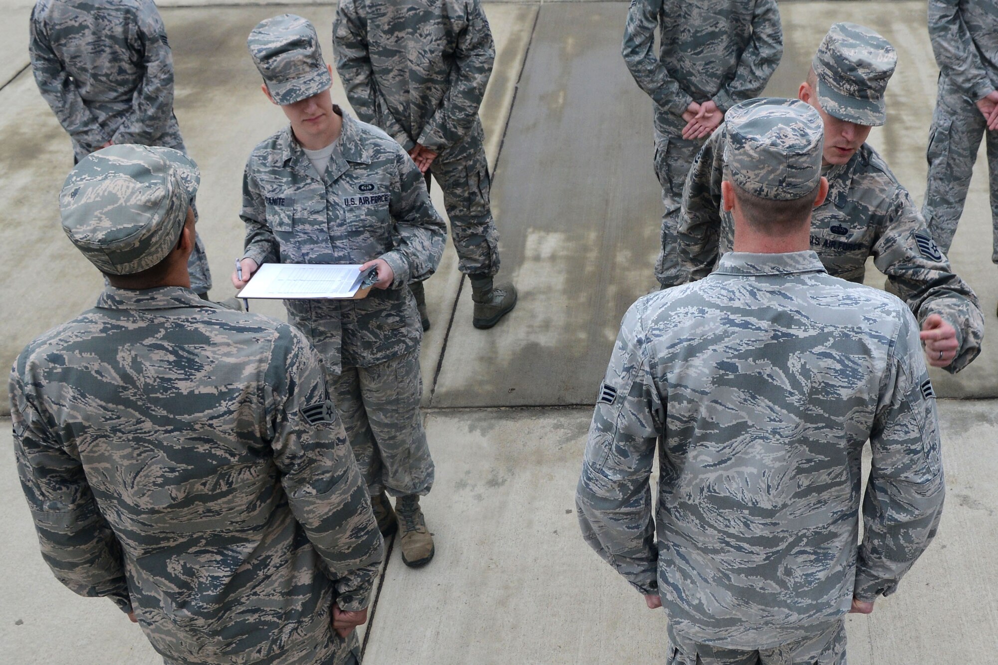 U.S. Air Force Airmen assigned to the Senior Master Sgt. David B. Reed Airman Leadership School Class 15-03 get their uniforms inspected by Staff Sgt. Caleb Hall, 20th Force Support Squadron ALS instructor, at Shaw Air Force Base S.C., March 5, 2015. Airmen attending ALS receive uniform inspections to ensure their uniforms meet Air Force regulation. (U.S. Air Force photo by Airman 1st Class Michael Cossaboom/Released)