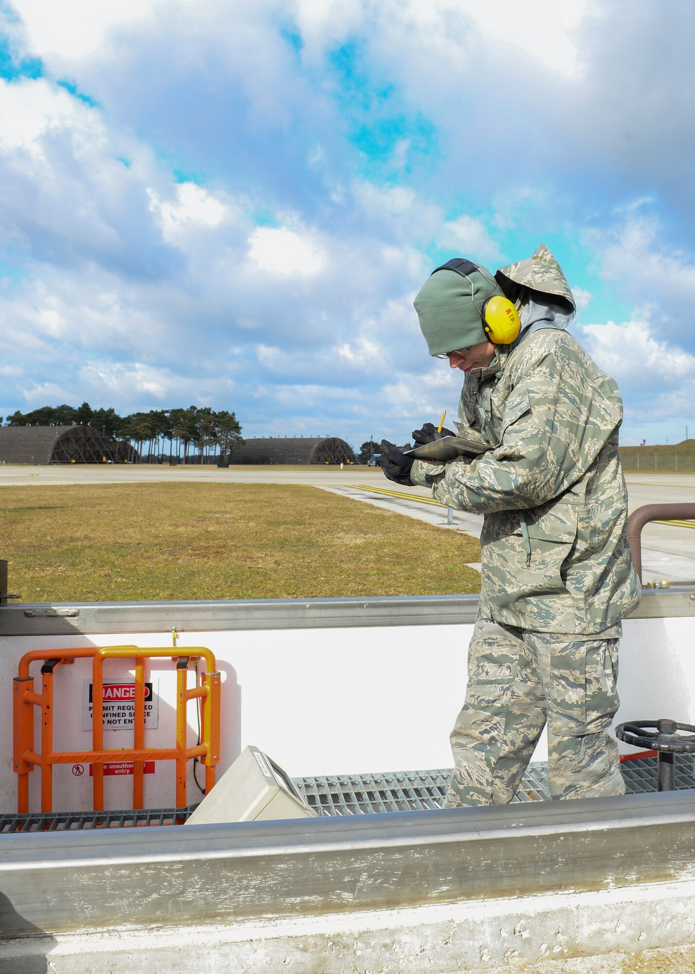 Senior Airman Jason Arms, 48th Aircraft Maintenance Squadron crew chief, annotates fuel meter readings of the hot-pit refueling system at Royal Air Force Lakenheath, England, Mar. 4, 2015. Airmen convert cubic liters into gallons ensuring jets receive the right amount of fuel. (U.S. Air Force photo by Senior Airman Nigel Sandridge/Released)