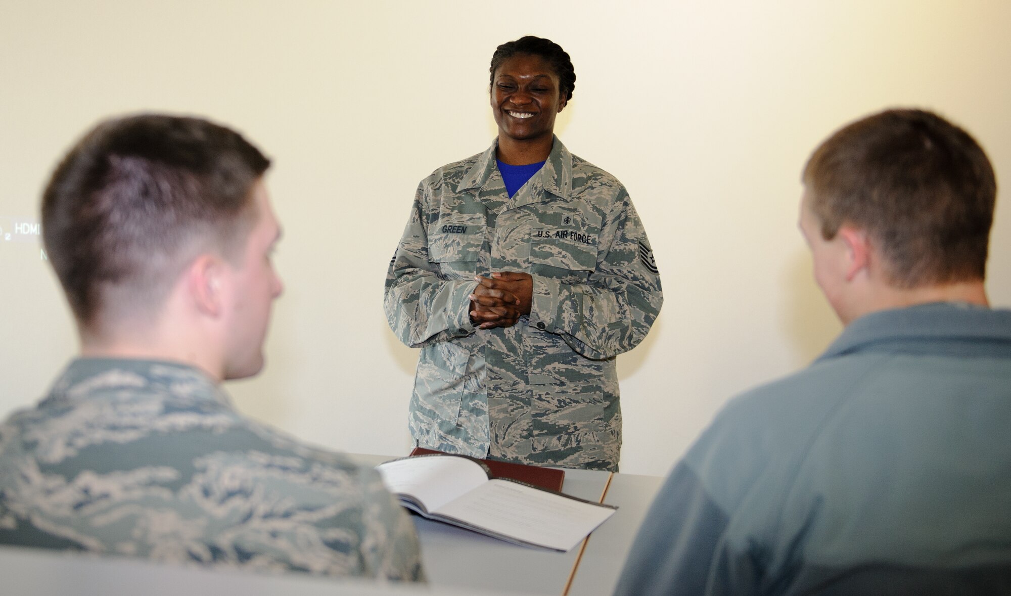 Tech. Sgt. Jessica Green, U.S. Air Forces in Europe and Air Forces Africa Surgeon General resource advisor, laughs while listening to Airmen during a leadership management class for young Airmen at Ramstein Air Base, Germany, March 6, 2015. Green was named the Air Force Medical Service Outstanding Enlisted Health Services Management NCO of the Year for 2014 due to her dedication to the mission, off duty volunteer work and accomplishments. (U.S. Air Force photo/Staff Sgt. Armando A. Schwier-Morales) 