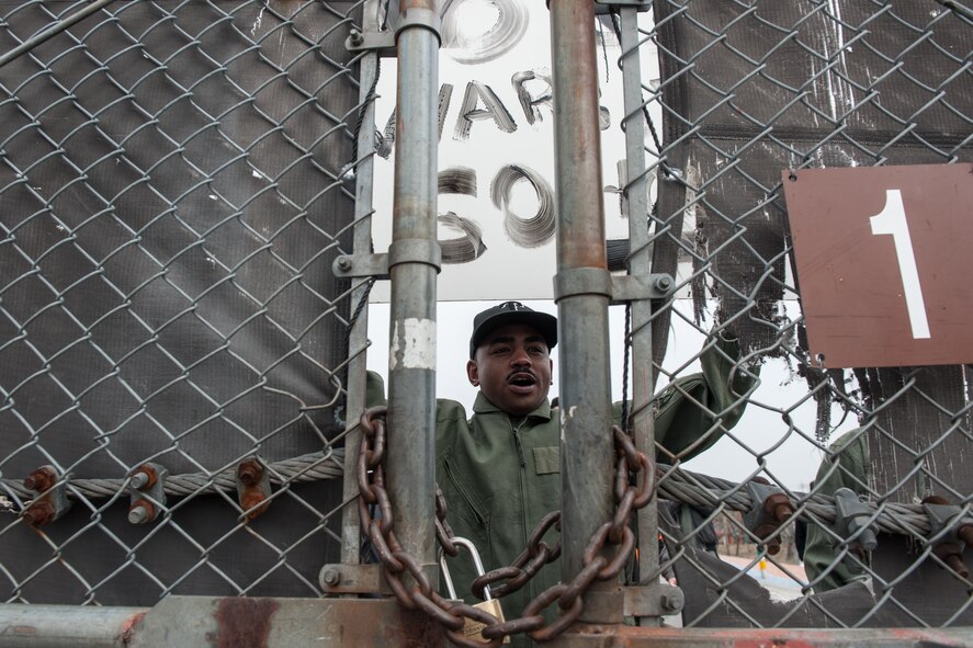 Airmen act as protesters at the north entrance of the base during a Exercise Beverly Midnight 15-2 scenario at Kunsan Air Base, Republic of Korea, March 3, 2015. BM 15-2 tests Airmen on their ability to survive and operate while under the stress of simulated wartime activities. (U.S. Air Force photo by Senior Airman Taylor Curry/Released) 