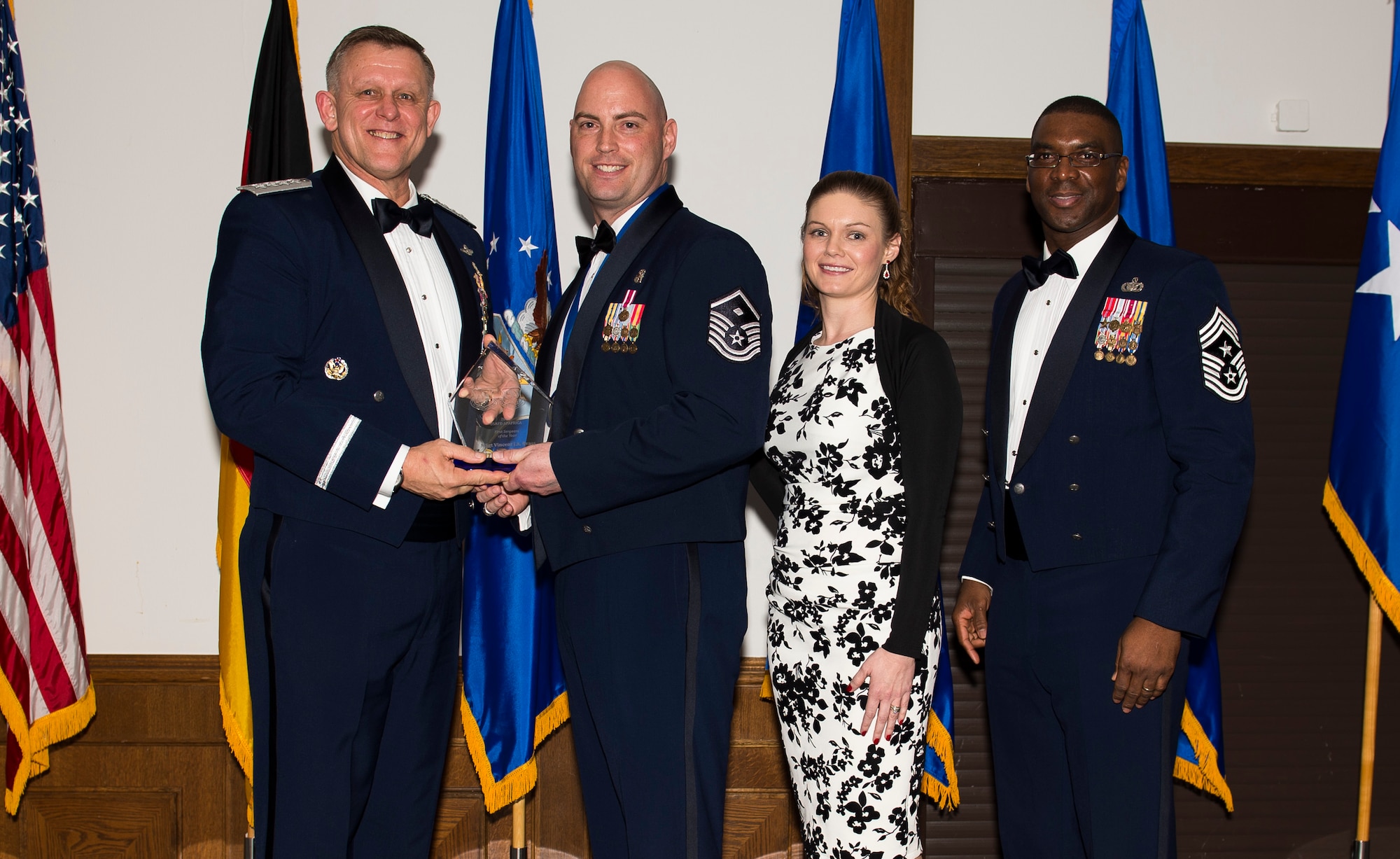 Master Sgt. Vincent Brass, 31st Logistics Readiness Squadron first sergeant, receives his U.S. Air Forces in Europe and Air Forces Africa First Sergeant of the Year award from Gen. Frank Gorenc, USAFE-AFAFRICA commander and Chief Master Sgt. James E. Davis, USAFE-AFAFRICA command chief, during an annual awards ceremony at Ramstein Air Base Germany, March 5, 2015. The Airmen competed within their units, then at the wing level and have now been named the best in USAFE-AFAFRICA. They will go on to compete at the Air Force level for the coveted Outstanding Airmen of the Year award which will be announced later this year. (U.S. Air Force photo/ Senior Airman Damon Kasberg)