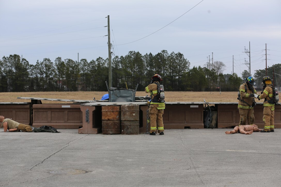 Firefighters evaluate the scene of a simulated vehicle borne IED near Cunningham Gate during the 2015 Crisis Response Drill at Marine Corps Air Station Cherry Point, N.C., March 3, 2015.  The annual exercise was designed to test Cherry Point’s emergency preparedness program and response procedures.