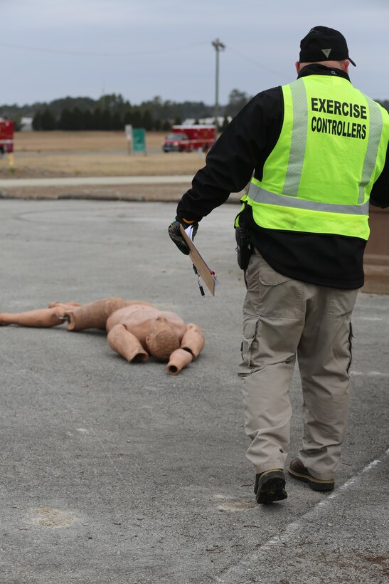 An exercise controller with the Marine Corps Regional Exercise Team East approaches a staged victim prior to the start of the 2015 Crisis Response Drill at Marine Corps Air Station Cherry Point, N.C., March 3, 2015.  The annual exercise is designed to test Cherry Point’s emergency preparedness program and response procedures.