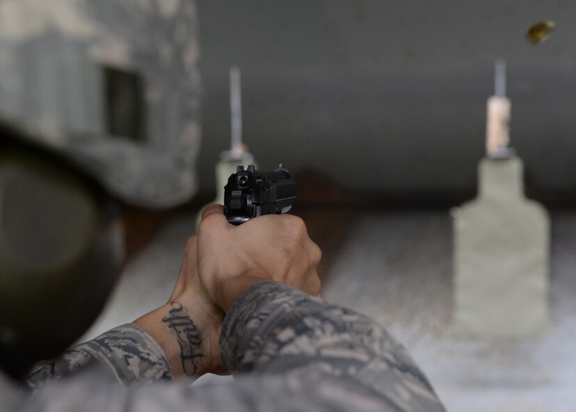 U.S. Air Force Airman 1st Class Juan Joubert, 97th Security Forces Squadron response force member, fires at a target during pistol qualification training at the combat arms firing range at Altus Air Force Base, Oklahoma, March 3, 2015. During the course, Airmen review the anatomy of the Berretta M9 pistol, how to handle the weapon, and must fire at a target seven, 15 and 25 meters away. (U.S. Air Force photo by Airman 1st Class Nathan Clark)