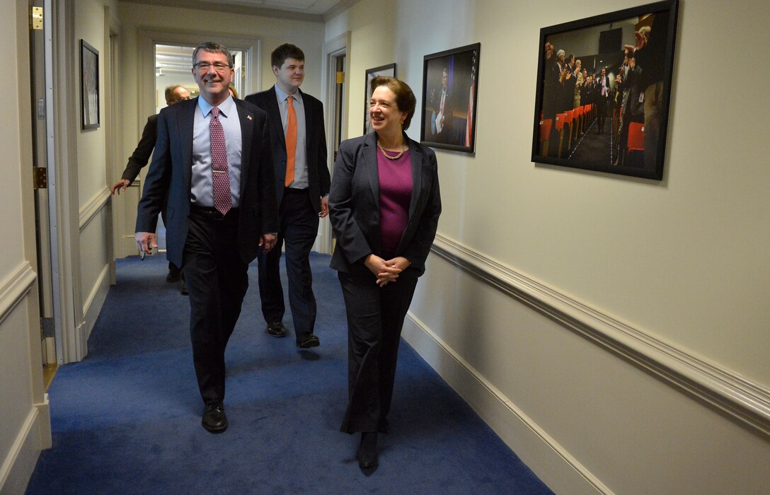 Defense Secretary Ash Carter and Supreme Court Justice Elena Kagan leave Carter's office to go to the Pentagon's auditorium, March 6, 2015, where Kagan will administer the oath of office to Carter.