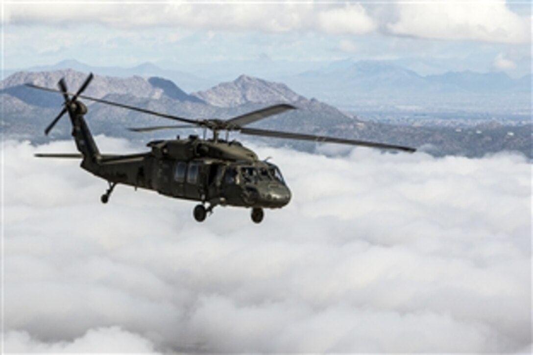 An Arizona Army National Guard UH-60 Black Hawk helicopter soars over a low layer of clouds during a flight to the Western Army Aviation Training site in Marana, Ariz., March 4, 2015. The helicopter crew is assigned to 2nd Assault Helicopter Battalion, 285th Aviation Regiment.