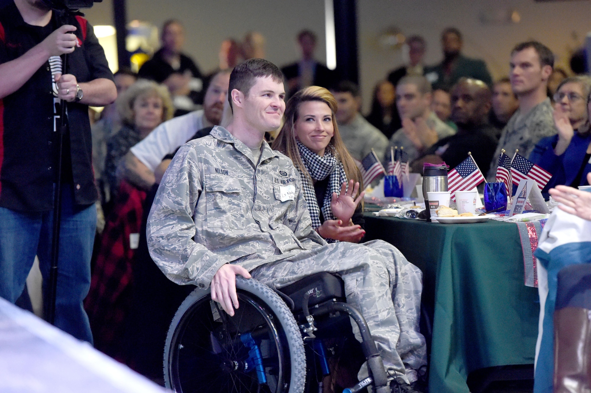 Building Homes for Heroes officials surprise Air Force Special Operations Command Air Commando 1st Lt. Nate Nelson and his wife with a new mortgage-free home during a Fort Walton Beach Chamber of Commerce breakfast, March 6, 2015. While deployed to a forward operating location in Afghanistan in 2013, Nelson was injured when an enemy rocket impacted the building wall he was sleeping against.(Courtesy photo by Nick Tomecek/Northwest Florida Daily News)