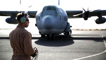 A U.S. Marine aircraft crewman with Marine Aerial Refueler Transport Squadron 352, Special Purpose Marine Air Ground Task Force – Crisis Response – Central Command, performs pre-flight checks on a KC-130J Hercules aircraft before takeoff in the Central Command area of operations, Feb. 23, 2015. The Marines, sailors and aircraft with VMGR 352 support SPMAGTF – CR – CC by transporting supplies, equipment, and personnel to various locations in the region.