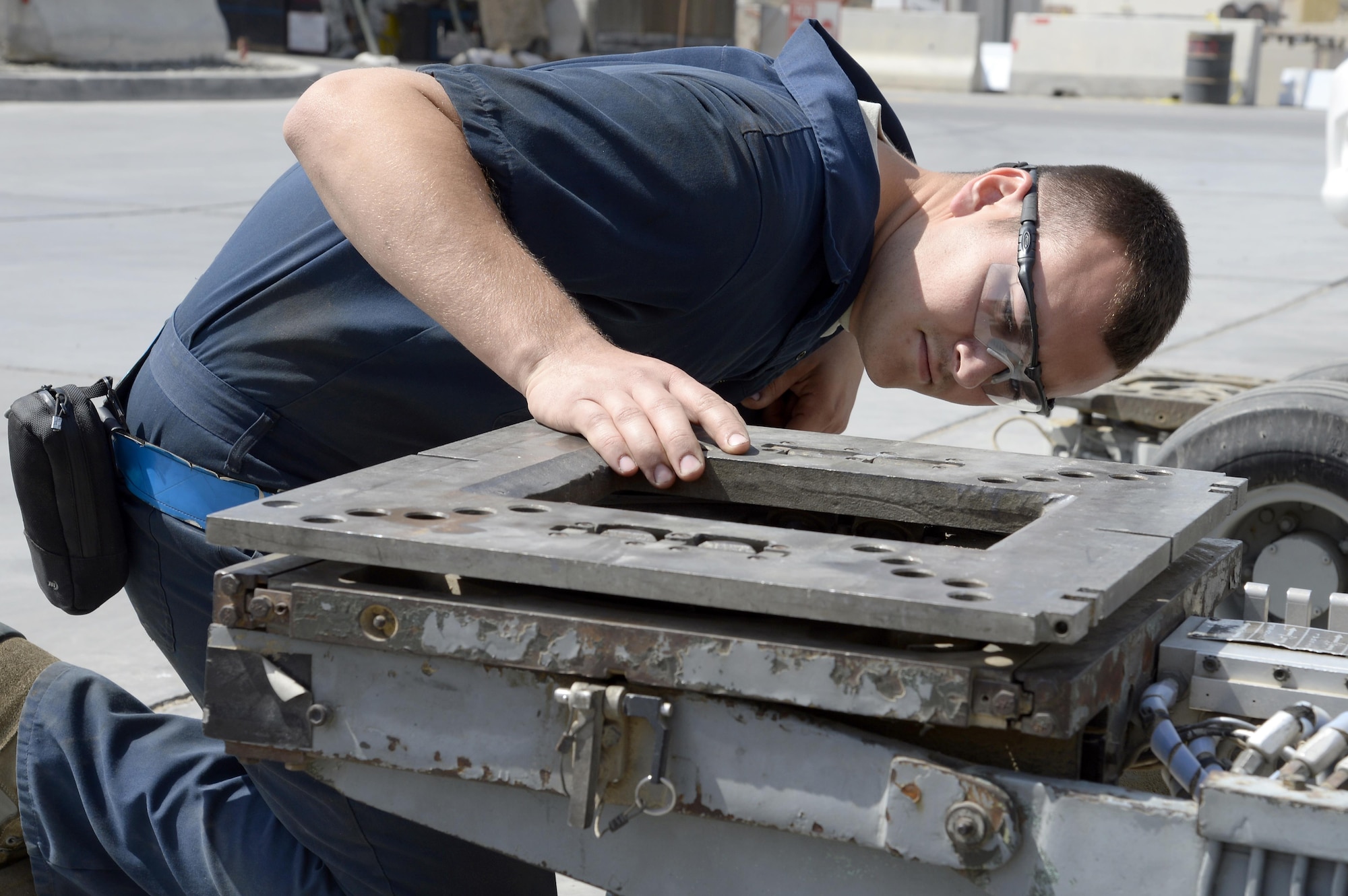 Senior Airman Michael, AGE journeyman, checks for a leak on a MJ-1B Jammer at an undisclosed location in Southwest Asia Mar. 3, 2015. AGE is comprised of Airmen from nine different air force bases and three major commands that work together to contribute to their overall mission. Michael is currently deployed from Hill Air Force Base, Utah and is a native of Burleson, Texas. (U.S. Air Force photo/Tech. Sgt. Marie Brown) (RELEASED)