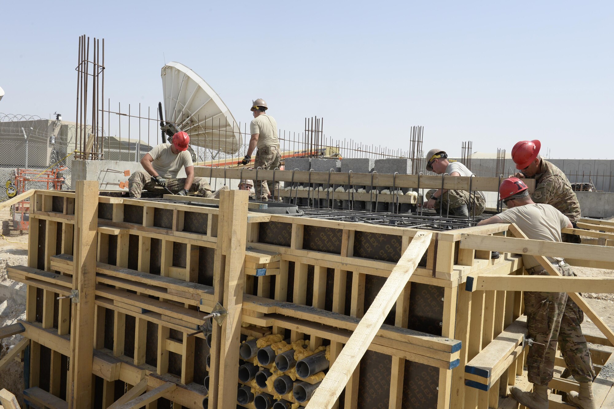 Airmen with the Expeditionary Prime Base Engineer Emergency Force Squadron work to construct a concrete electrical vault at an undisclosed location in Southwest Asia Mar. 4, 2015. EPBS does cradle to grave construction consisting of small to medium construction projects from programming to real estate capitalization.  (U.S. Air Force photo/Tech. Sgt. Marie Brown) (RELEASED)