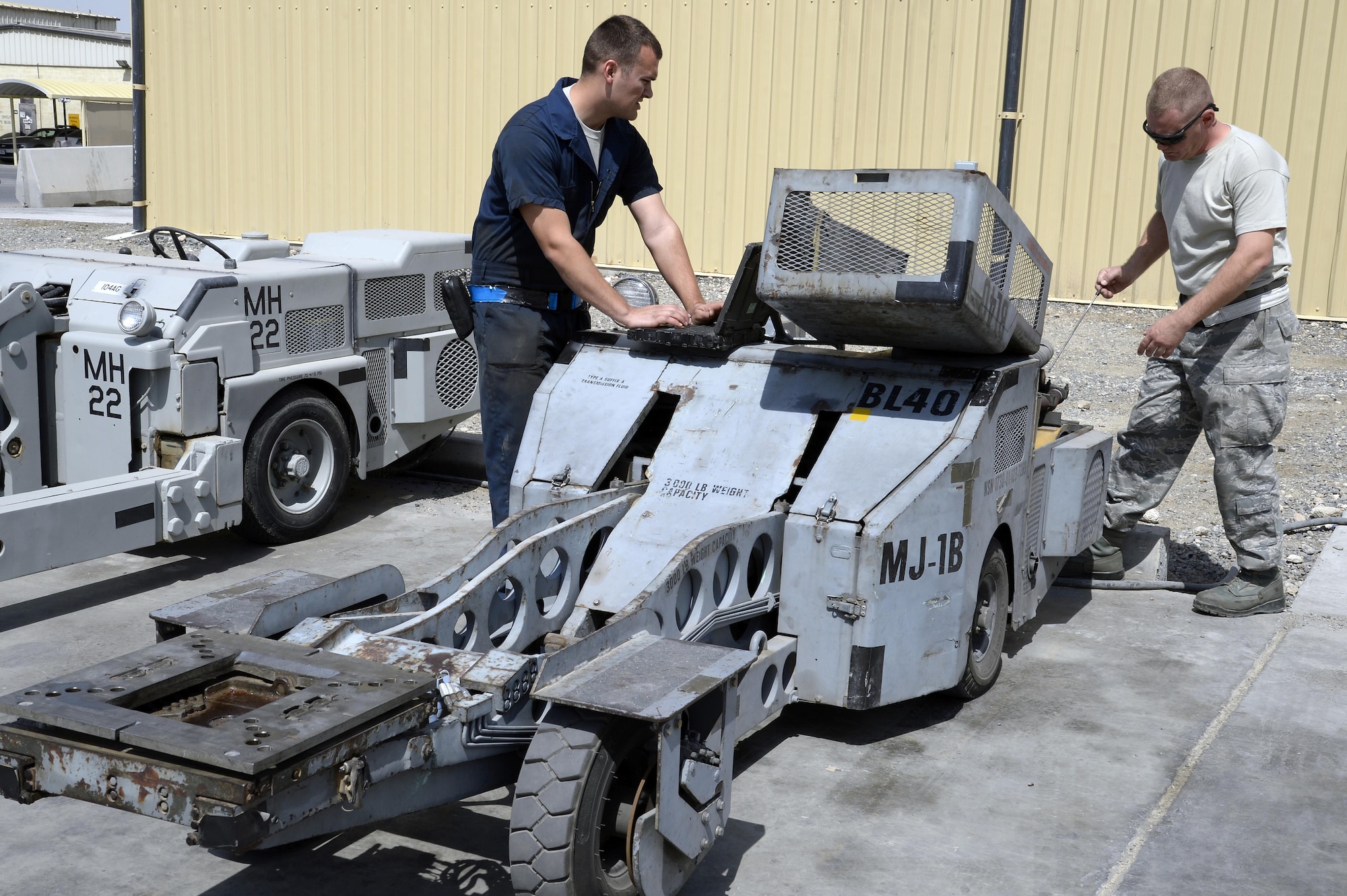 Staff Sgt. Nicholas, right, Aerospace Ground Equipment assistant floor lead, and Senior Airman Michael, AGE journeyman, performs general maintenance on a MJ-1B Jammer at an undisclosed location in Southwest Asia Mar. 3, 2015. The AGE flight provides equipment such as hydraulic test stands, diesel generators, gas turbine generators, air conditioning units, heaters, jacks, maintenance stands, nitrogen carts, lights and more to support six different airframes. Nicholas is currently deployed from Seymour Johnson Air Force Base, N.C., and is a native of Geraldine, Ala. Michael is currently deployed from Hill Air Force Base, Utah and is a native of Burleson, Texas. (U.S. Air Force photo/Tech. Sgt. Marie Brown) (RELEASED)