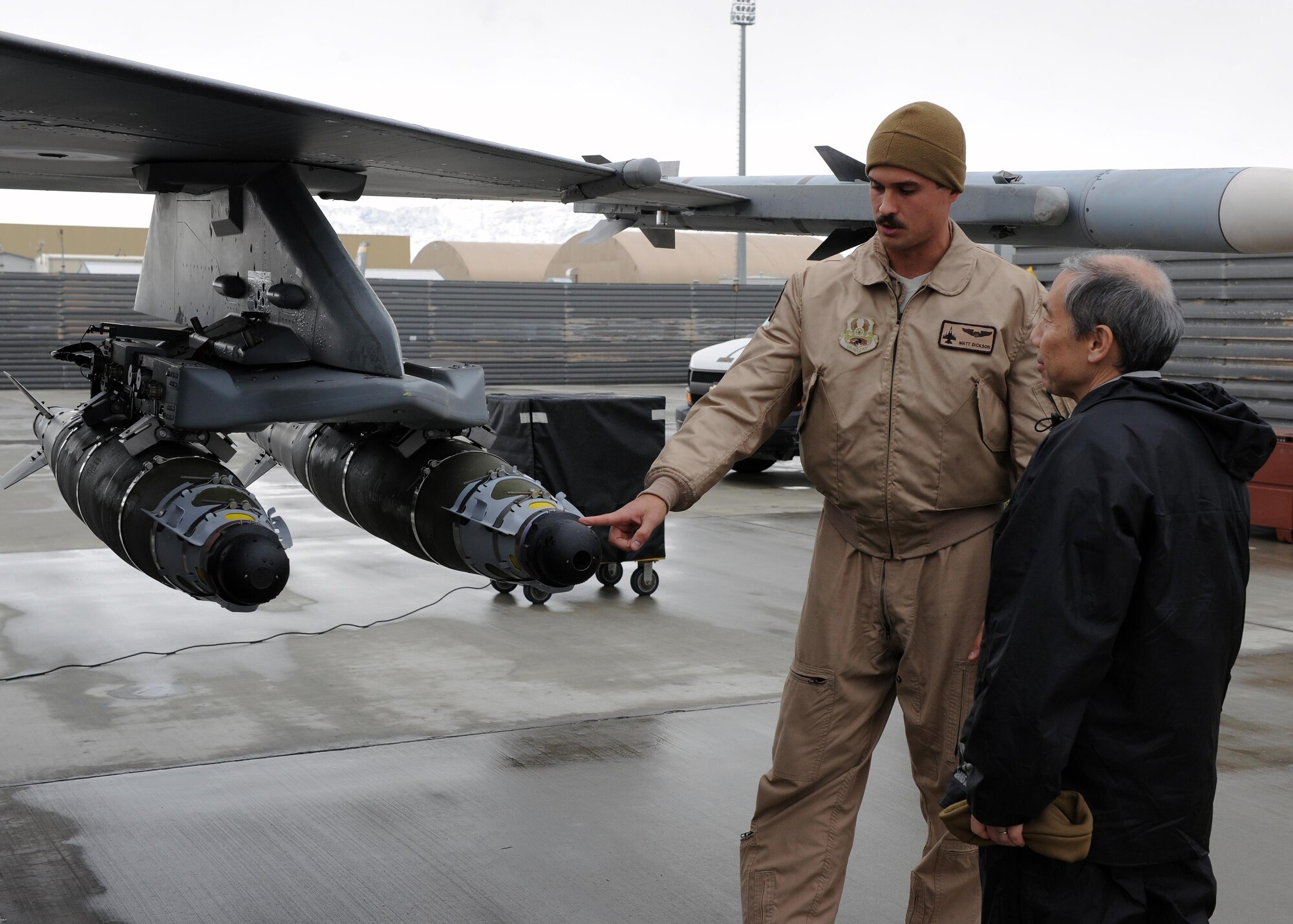 U.S. Air Force Capt. Matt Dickson, 4th Expeditionary Fighter Squadron F-16 pilot, describes the capabilities of an F-16 Fighting Falcon to Ambassador Donald Yamamoto, Principal Deputy Assistant Secretary in the Bureau of African Affairs, during a tour of the 455th Air Expeditionary Wing March 7, 2015 at Bagram Airfield, Afghanistan. Throughout the tour, Yamamoto, who served as the U.S. Ambassador to the Federal Democratic Republic of Ethiopia from November 2006 to July 2009, received mission briefs from squadron leadership and became more familiar with Air Force assets and personnel here. (U.S. Air Force photo by Staff Sgt. Whitney Amstutz/released)