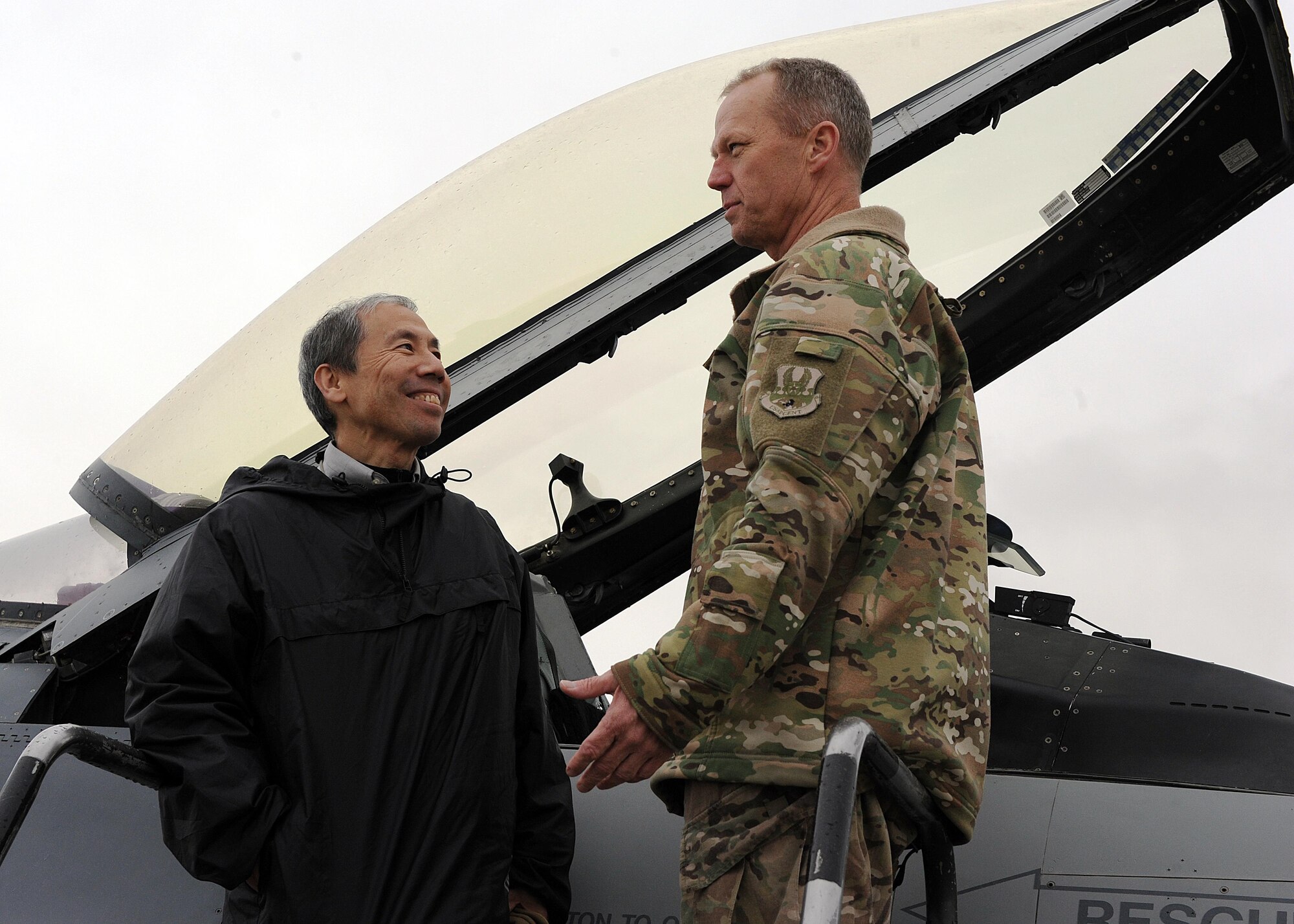U.S. Air Force Brig. Gen. Mark Kelly, 455th Air Expeditionary Wing commander, and Ambassador Donald Yamamoto, Principal Deputy Assistant Secretary in the Bureau of African Affairs, discuss the capabilities of the F-16 Fighting Falcon during a tour of the 455 AEW March 7, 2015 at Bagram Airfield, Afghanistan. Throughout the tour, Yamamoto, who served as the U.S. Ambassador to the Federal Democratic Republic of Ethiopia from November 2006 to July 2009, received mission briefs from squadron leadership and became more familiar with Air Force assets and personnel here. (U.S. Air Force photo by Staff Sgt. Whitney Amstutz/released)