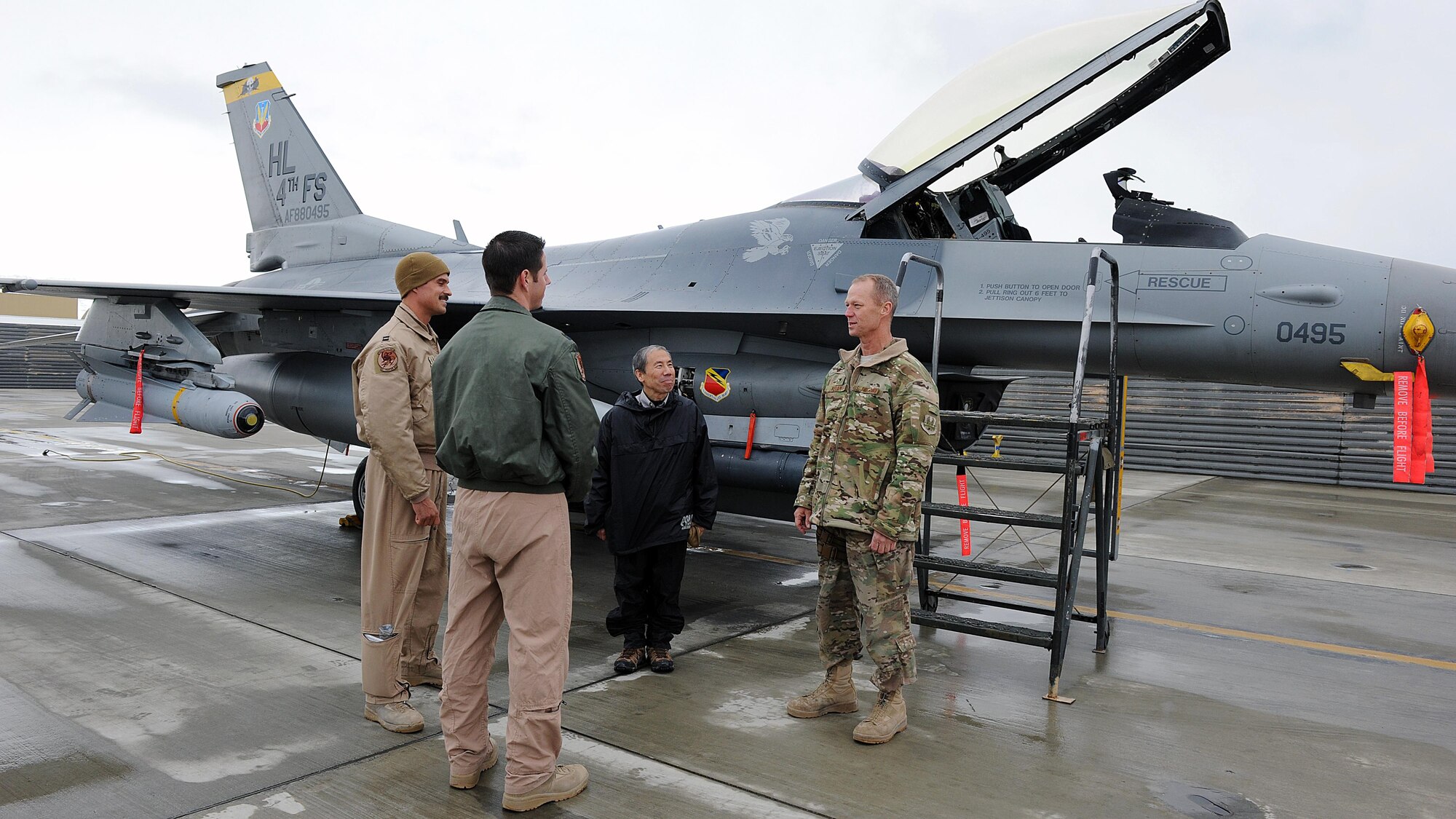 U.S. Air Force Brig. Gen. Mark Kelly, 455th Air Expeditionary Wing commander, U.S. Air Force Capt. Matt Dickson and U.S. Air Force Capt. Michael Blackburn, 4th Expeditionary Fighter Squadron F-16 pilots, speak with Ambassador Donald Yamamoto, Principal Deputy Assistant Secretary in the Bureau of African Affairs, during a tour of the 455 AEW March 7, 2015 at Bagram Airfield, Afghanistan. Throughout the tour, Yamamoto, who served as the U.S. Ambassador to the Federal Democratic Republic of Ethiopia from November 2006 to July 2009, received mission briefs from squadron leadership and became more familiar with Air Force assets and personnel here. (U.S. Air Force photo by Staff Sgt. Whitney Amstutz/released)